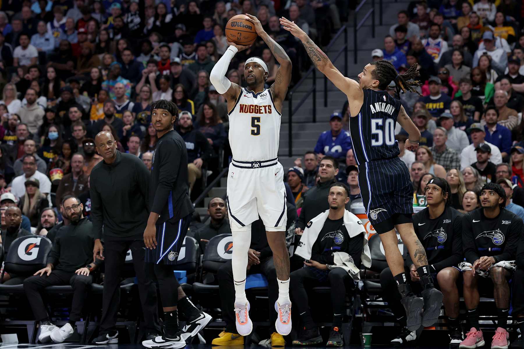 DENVER, COLORADO - JANUARY 15: Kentavious Caldwell-Pope #5 of the Denver Nuggets puts up a shot against Cole Anthony #50 of the Orlando Magic in the fourth quarter at Ball Arena on January 15, 2023 in Denver, Colorado. NOTE TO USER: User expressly acknowledges and agrees that, by downloading and/or using this photograph, User is consenting to the terms and conditions of the Getty Images License Agreement. (Photo by Matthew Stockman/Getty Images)