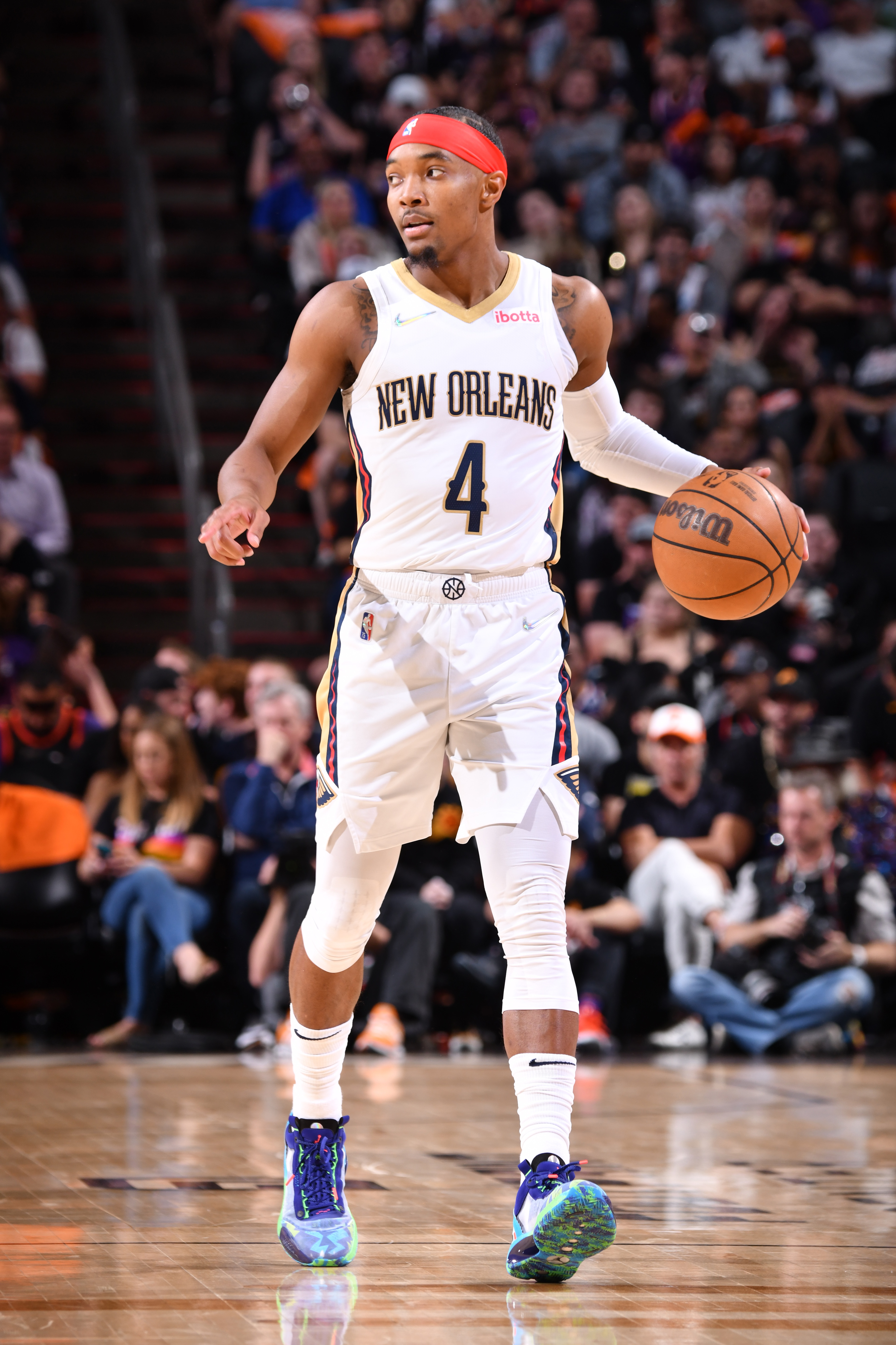 PHOENIX, AZ - APRIL 26: Devonte' Graham #4 of the New Orleans Pelicans dribbles the ball against the Phoenix Suns during Round 1 Game 5 of the 2022 NBA Playoffs on April 26, 2022 at Footprint Center in Phoenix, Arizona. NOTE TO USER: User expressly acknowledges and agrees that, by downloading and or using this photograph, user is consenting to the terms and conditions of the Getty Images License Agreement. Mandatory Copyright Notice: Copyright 2022 NBAE (Photo by Barry Gossage/NBAE via Getty Images)