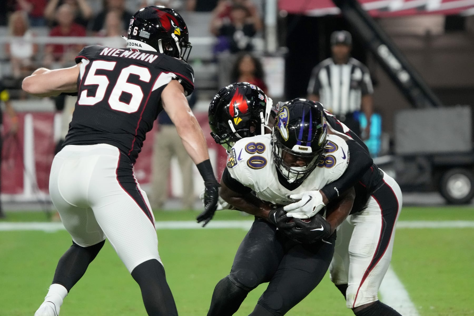 Baltimore Ravens tight end Isaiah Likely (80) scores a touchdown as Arizona Cardinals linebacker Ben Niemann (56) defends during the first half of an NFL preseason football game, Sunday, Aug. 21, 2022, in Glendale, Ariz. (AP Photo/Rick Scuteri)