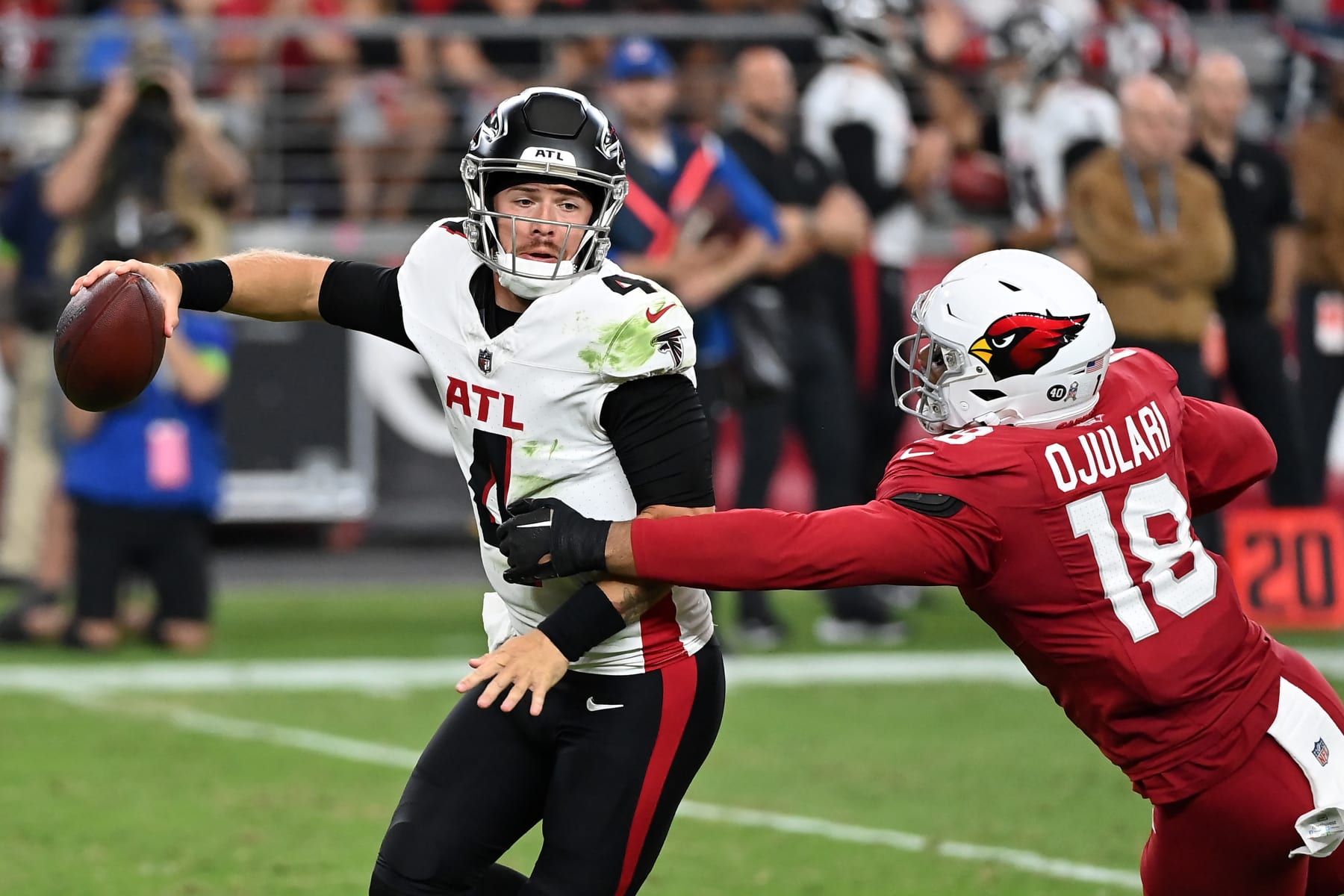 GLENDALE, ARIZONA - NOVEMBER 12: Taylor Heinicke #4 of the Atlanta Falcons attempts to avoid a sack against BJ Ojulari #18 of the Arizona Cardinals during the third quarter at State Farm Stadium on November 12, 2023 in Glendale, Arizona. (Photo by Norm Hall/Getty Images)