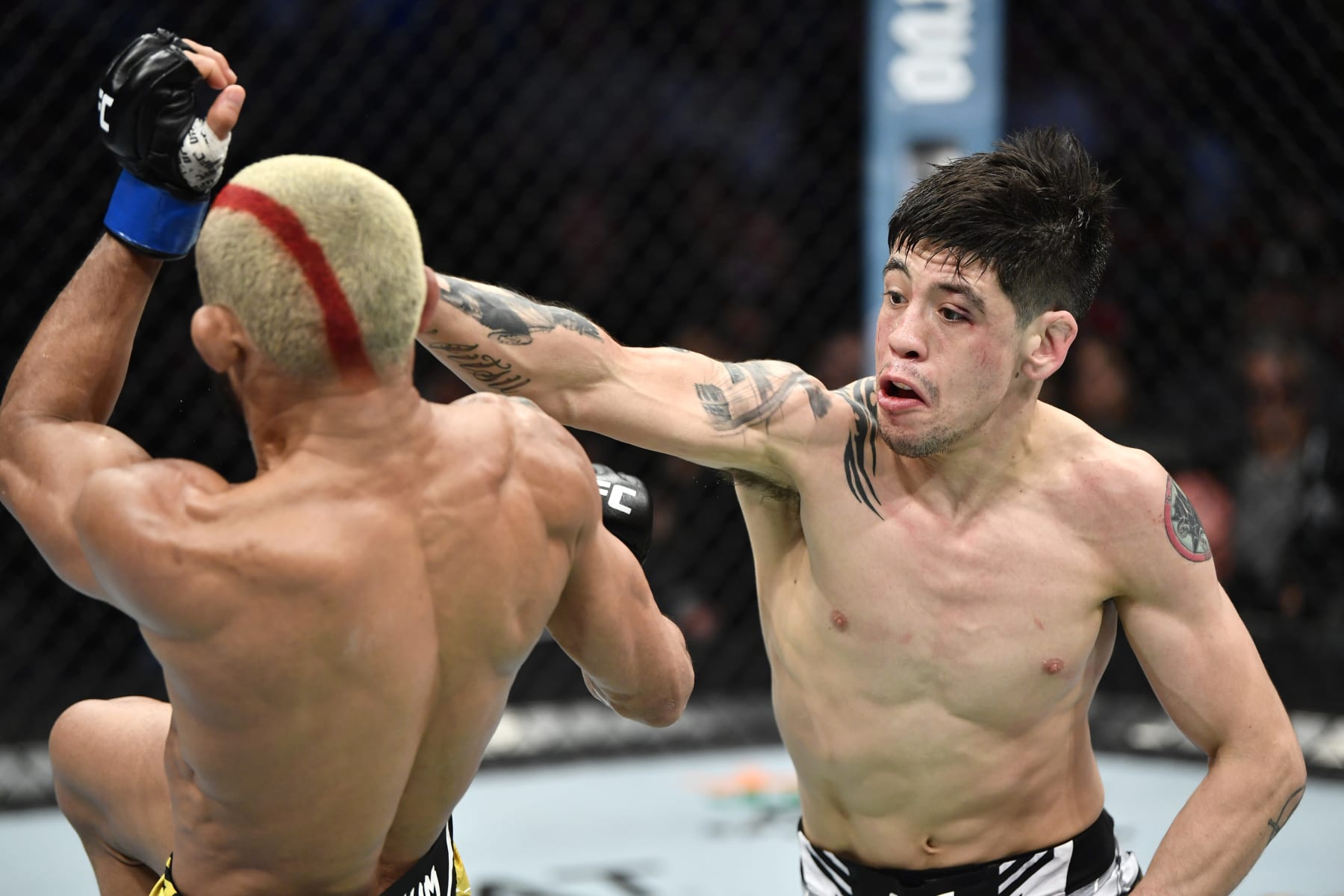 ANAHEIM, CALIFORNIA - JANUARY 22: (R-L) Brandon Moreno of Mexico punches Deiveson Figueiredo of Brazil in their UFC flyweight championship fight during the UFC 270 event at Honda Center on January 22, 2022 in Anaheim, California. (Photo by Chris Unger/Zuffa LLC)