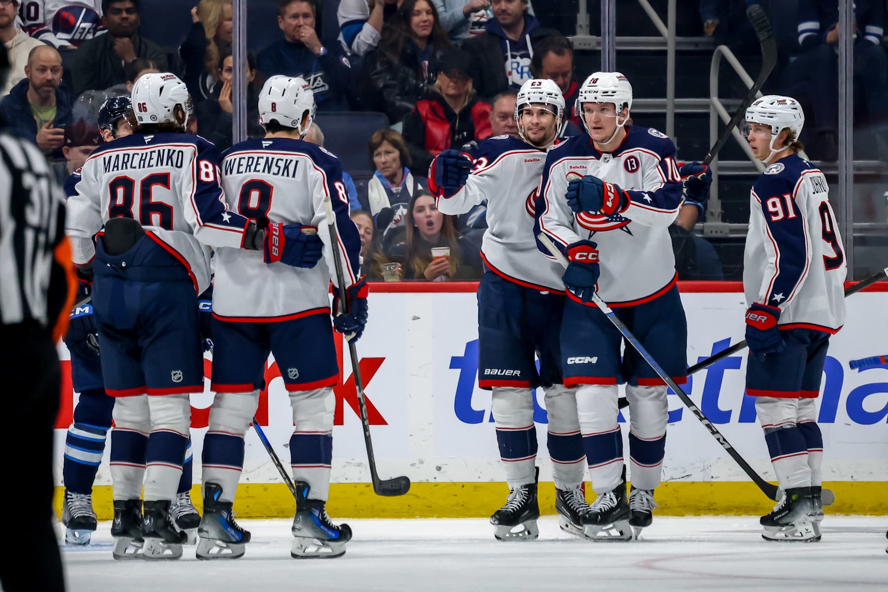 WINNIPEG, CANADA - DECEMBER 8: Kirill Marchenko #86, Zach Werenski #8, Sean Monahan #23, Dmitri Voronkov #10 and Kent Johnson #91 of the Columbus Blue Jackets celebrate a second period goal against the Winnipeg Jets at the Canada Life Centre on December 8, 2024 in Winnipeg, Manitoba, Canada. (Photo by Jonathan Kozub/NHLI via Getty Images)
