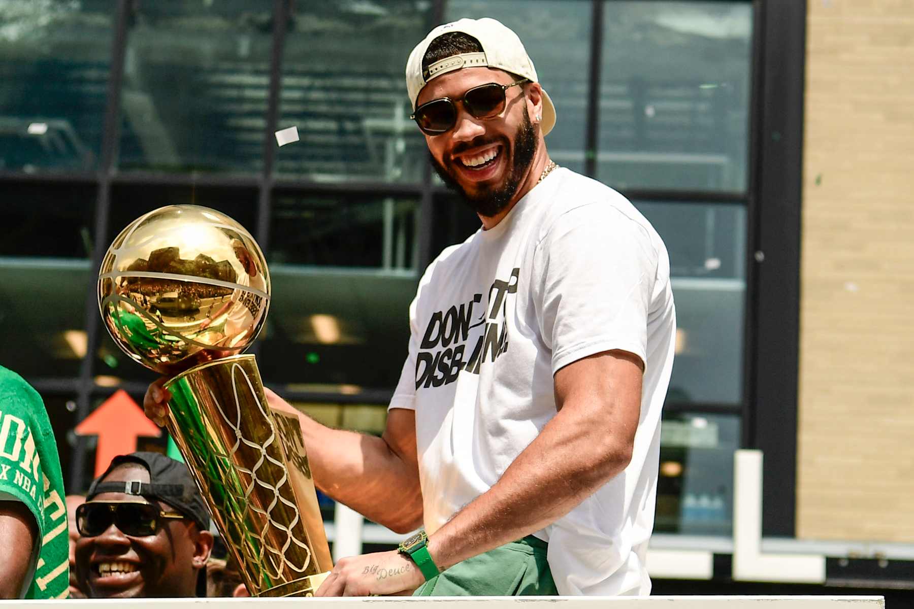 BOSTON, MASSACHUSETTS - JUNE 21: Jayson Tatum #0 of the Boston Celtics reacts as he holds the Larry O'Brien Championship Trophy during the 2024 Boston Celtics championship parade following their 2024 NBA Finals win on June 21, 2024 in Boston, Massachusetts.  (Photo by Billie Weiss/Getty Images)