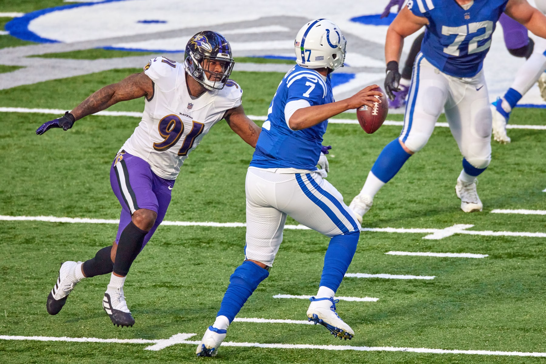 INDIANAPOLIS, IN - NOVEMBER 08: Baltimore Ravens defensive end Yannick Ngakoue (91) battles with Indianapolis Colts quarterback Jacoby Brissett (7) in action during a NFL game between the Indianapolis Colts and the Baltimore Ravens on November 08, 2020 at Lucas Oil Stadium in Indianapolis, IN. (Photo by Robin Alam/Icon Sportswire via Getty Images)