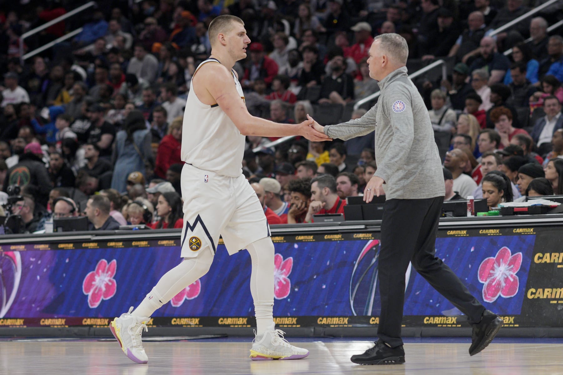 WASHINGTON, DC - MARCH 22: Nikola Jokic #15 of the Denver Nuggets slaps hands with head coach Michael Malone during the second half against the Washington Wizards at Capital One Arena on March 22, 2023 in Washington, DC. NOTE TO USER: User expressly acknowledges and agrees that, by downloading and or using this photograph, User is consenting to the terms and conditions of the Getty Images License Agreement. (Photo by Jess Rapfogel/Getty Images) WASHINGTON, DC - MARCH 22: Nikola Jokic #15 of the Denver Nuggets slaps hands with head coach Michael Malone during the second half against the Washington Wizards at Capital One Arena on March 22, 2023 in Washington, DC. NOTE TO USER: User expressly acknowledges and agrees that, by downloading and or using this photograph, User is consenting to the terms and conditions of the Getty Images License Agreement. (Photo by Jess Rapfogel/Getty Images)