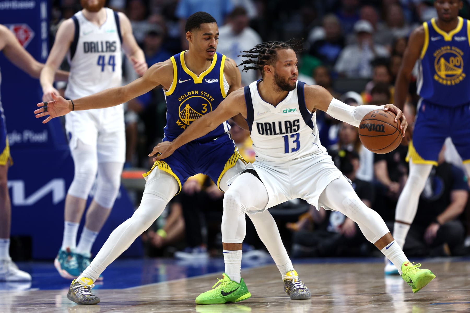 DALLAS, TEXAS - MAY 24: Jalen Brunson #13 of the Dallas Mavericks dribbles against Jordan Poole #3 of the Golden State Warriors during the fourth quarter in Game Four of the 2022 NBA Playoffs Western Conference Finals at American Airlines Center on May 24, 2022 in Dallas, Texas. NOTE TO USER: User expressly acknowledges and agrees that, by downloading and or using this photograph, User is consenting to the terms and conditions of the Getty Images License Agreement. (Photo by Tom Pennington/Getty Images)