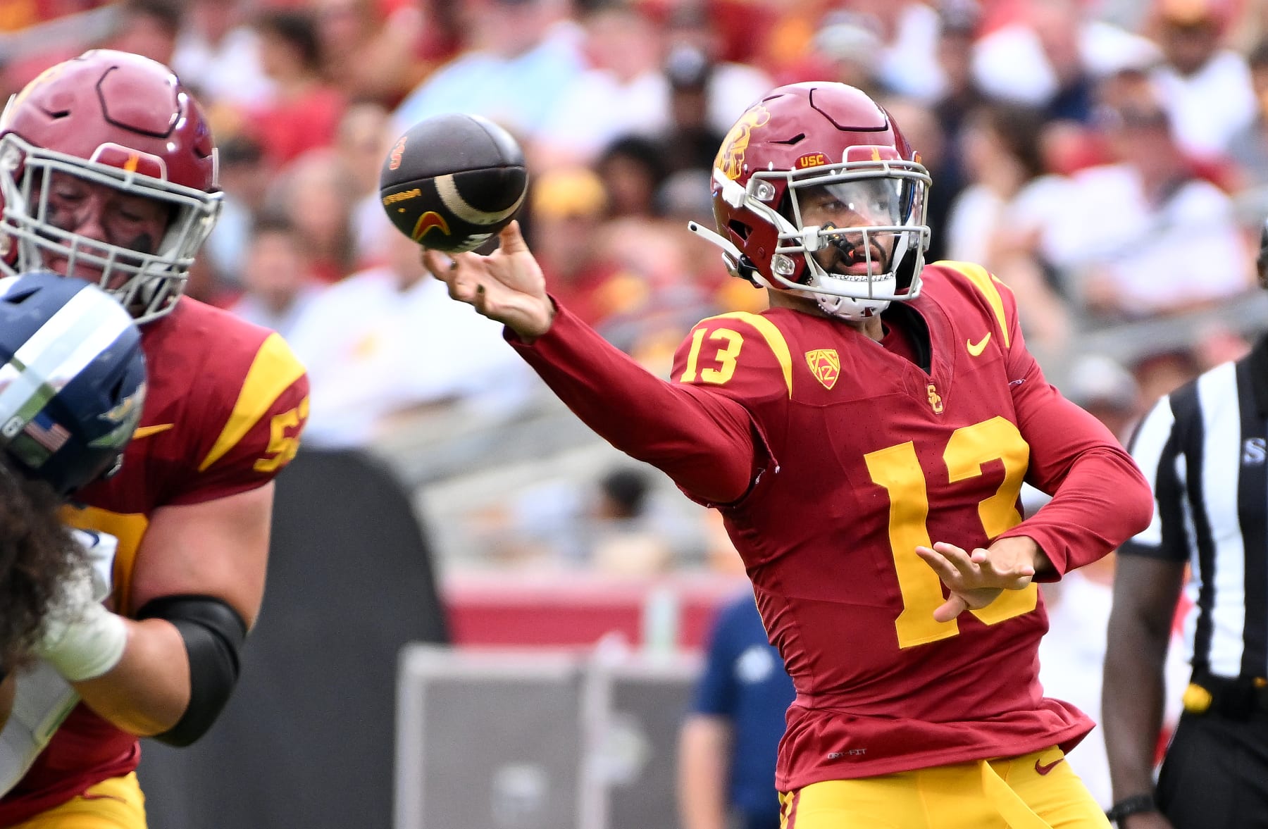 Los Angeles, California September 2, 2023-USC quarterback Caleb Williams throws a touchdown pass against Nevada in the first quarter at the Coliseum Saturday. (Wally Skalij/Los Angles Times)