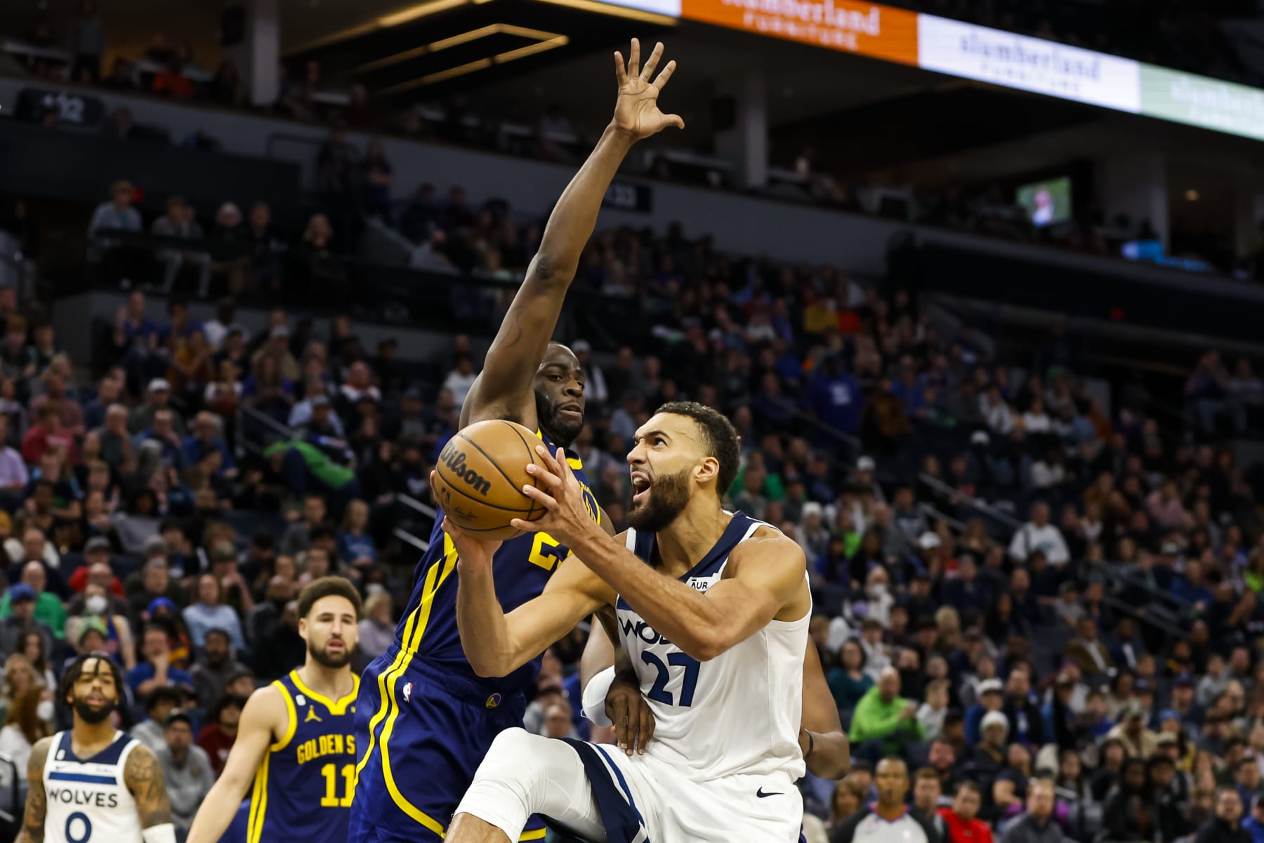 MINNEAPOLIS, MN - NOVEMBER 27: Rudy Gobert #27 of the Minnesota Timberwolves drives to the basket against Draymond Green #23 of the Golden State Warriors in the fourth quarter at Target Center on November 27, 2022 in Minneapolis, Minnesota. The Warriors defeated the Timberwolves 137-114. NOTE TO USER: User expressly acknowledges and agrees that, by downloading and or using this Photograph, user is consenting to the terms and conditions of the Getty Images License Agreement. (Photo by David Berding/Getty Images)