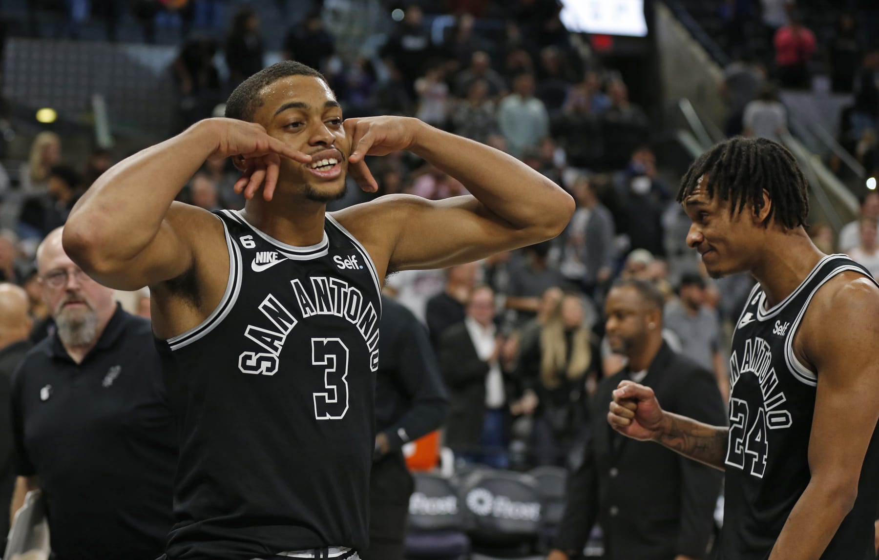 SAN ANTONIO, TX - DECEMBER 12:  Keldon Johnson #3 of the San Antonio Spurs and Devin Vassell #24 reacts after they defeated the Cleveland Cavaliers at AT&T Center on December 12, 2022 in San Antonio, Texas. NOTE TO USER: User expressly acknowledges and agrees that, by downloading and or using this photograph, User is consenting to terms and conditions of the Getty Images License Agreement. (Photo by Ronald Cortes/Getty Images)