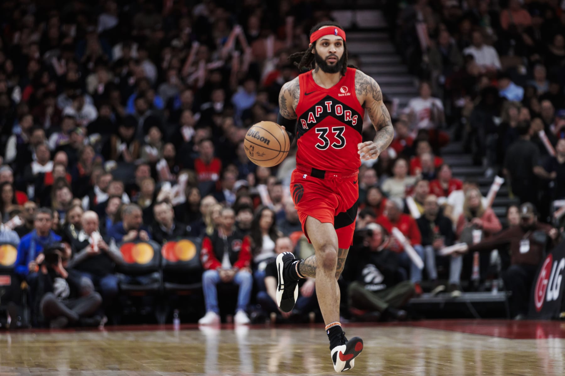 TORONTO, CANADA - FEBRUARY 28: Gary Trent Jr. #33 of the Toronto Raptors dribbles against the Dallas Mavericks second half of their NBA game at Scotiabank Arena on February 28, 2024 in Toronto, Canada. NOTE TO USER: User expressly acknowledges and agrees that, by downloading and or using this photograph, User is consenting to the terms and conditions of the Getty Images License Agreement. (Photo by Cole Burston/Getty Images)