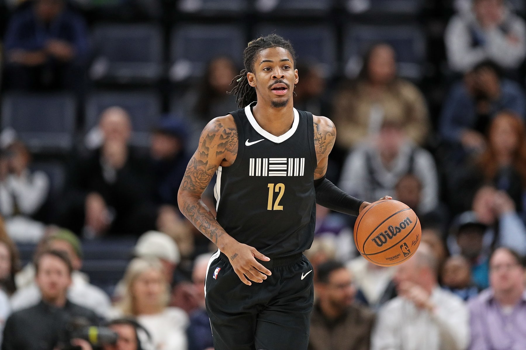 MEMPHIS, TENNESSEE - JANUARY 03: Ja Morant #12 of the Memphis Grizzlies brings the ball down court during the game against the Toronto Raptors at FedExForum on January 03, 2024 in Memphis, Tennessee. NOTE TO USER: User expressly acknowledges and agrees that, by downloading and or using this photograph, User is consenting to the terms and conditions of the Getty Images License Agreement. (Photo by Justin Ford/Getty Images)
