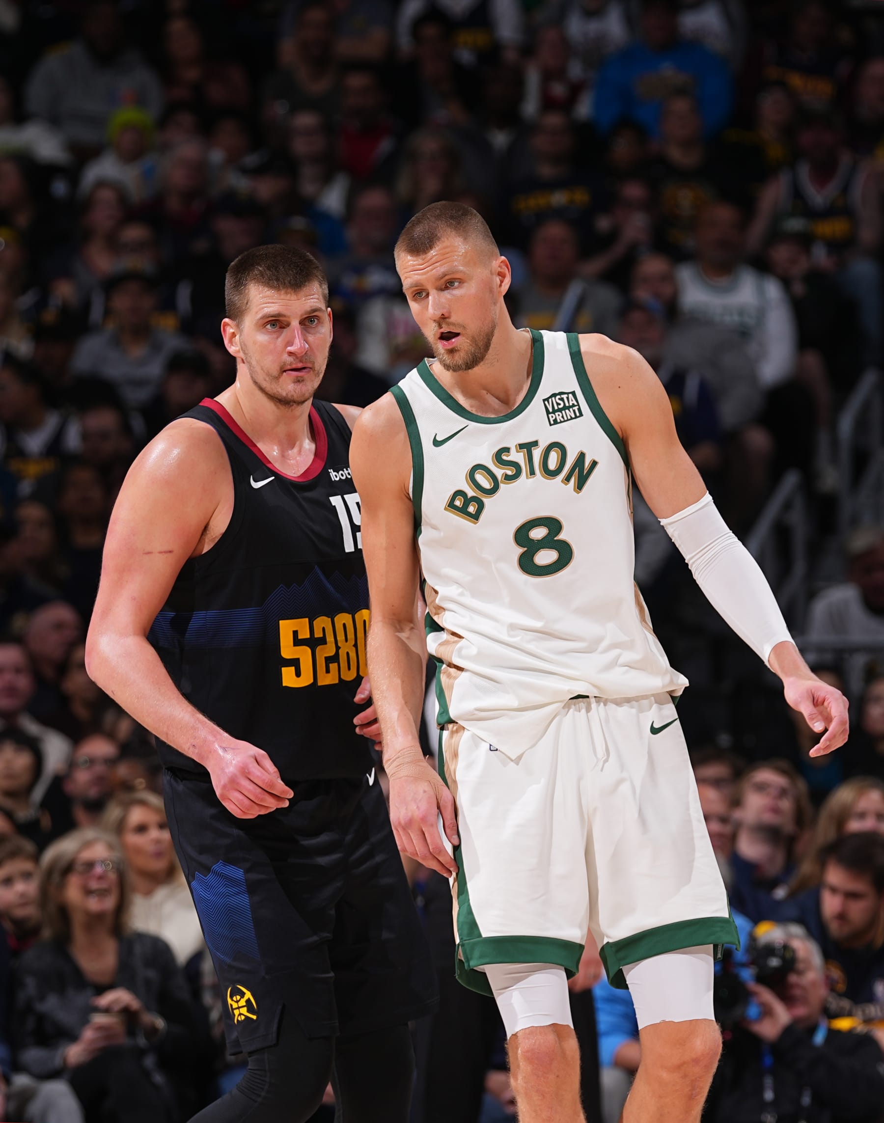 DENVER, CO - MARCH 7:  Kristaps Porzingis #8 of the Boston Celtics and Nikola Jokic #15 of the Denver Nuggets looks on during the game on March 7, 2024 at the Ball Arena in Denver, Colorado. NOTE TO USER: User expressly acknowledges and agrees that, by downloading and/or using this Photograph, user is consenting to the terms and conditions of the Getty Images License Agreement. Mandatory Copyright Notice: Copyright 2024 NBAE (Photo by Bart Young/NBAE via Getty Images)