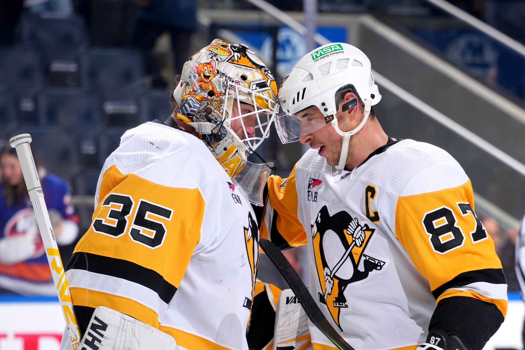ELMONT, NEW YORK - DECEMBER 27:  Tristan Jarry #35 and Sidney Crosby #87 of the Pittsburgh Penguins celebrate their 7-0 win against the New York Islanders at UBS Arena on December 27, 2023 in Elmont, New York. (Photo by Mike Stobe/NHLI via Getty Images)