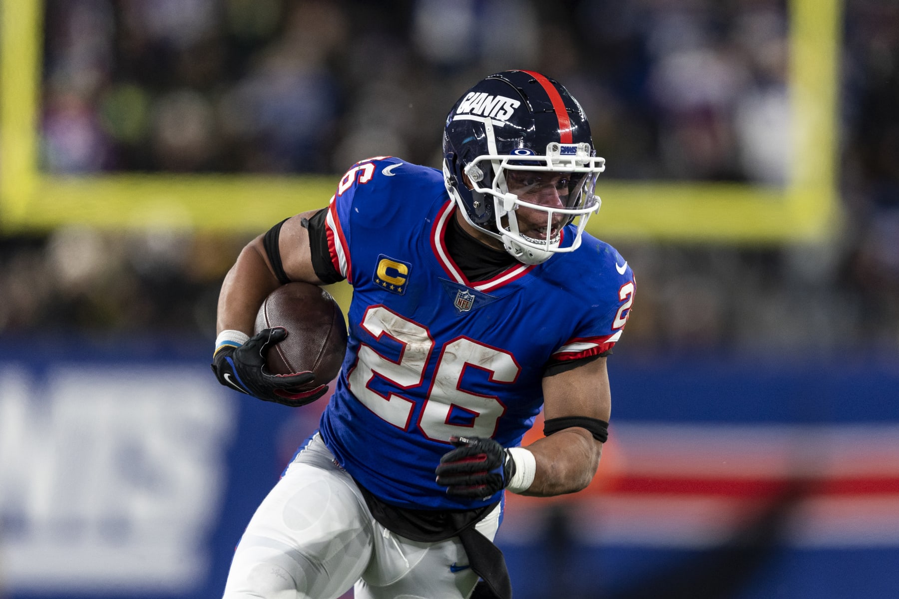 EAST RUTHERFORD, NEW JERSEY - DECEMBER 11: Saquon Barkley #26 of the New York Giants runs with the ball during an NFL football game between the New York Giants and the Green Bay Packers at MetLife Stadium on December 11, 2023 in East Rutherford, New Jersey. (Photo by Michael Owens/Getty Images)