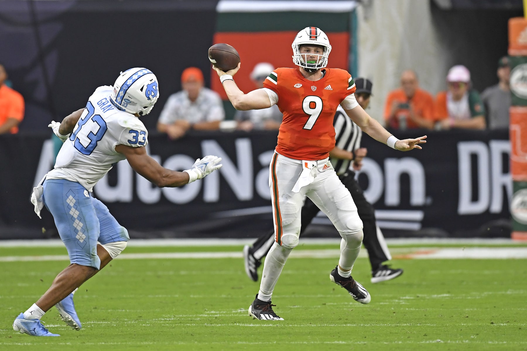 MIAMI GARDENS, FL - OCTOBER 08:  Miami quarterback Tyler Van Dyke (9) throws while on the run from North Carolina linebacker Cedric Gray (33) in the second quarter as the University of Miami Hurricanes faced the University of North Carolina at Chapel Hill Tar Heels on October 8, 2022, at Hard Rock Stadium in Miami Gardens, Florida. (Photo by Samuel Lewis/Icon Sportswire via Getty Images)
