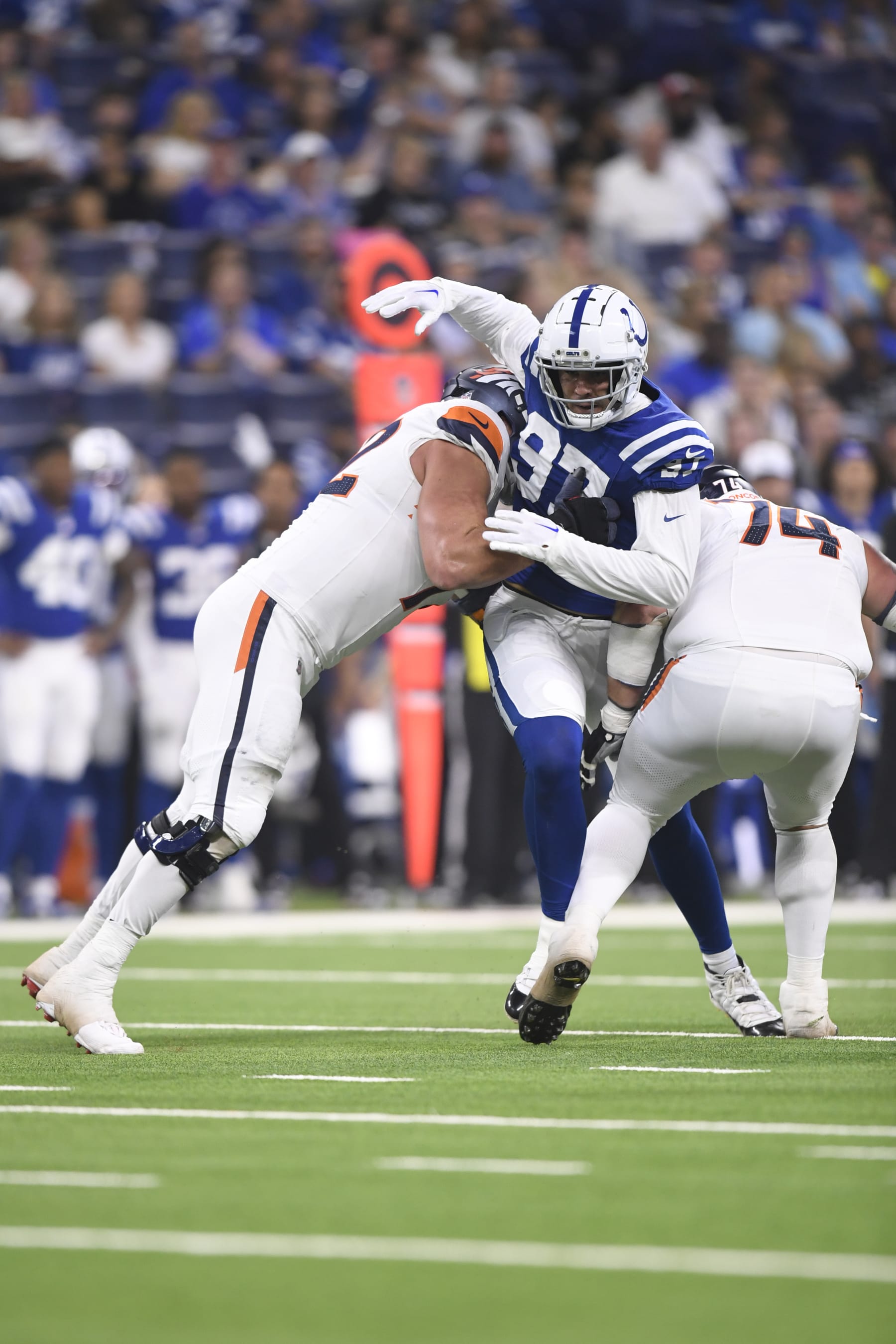 INDIANAPOLIS, IN - AUGUST 11: Denver Broncos Tackle Garett Bolles (72) and Denver Broncos Guard Ben Powers (74) block Indianapolis Colts Defensive End Laiatu Latu (97) during the NFL Preseason game between the Denver Broncos and the Indianapolis Colts on August 11, 2024, at Lucas Oil Stadium in Indianapolis, Indiana. (Photo by Michael Allio/Icon Sportswire via Getty Images)