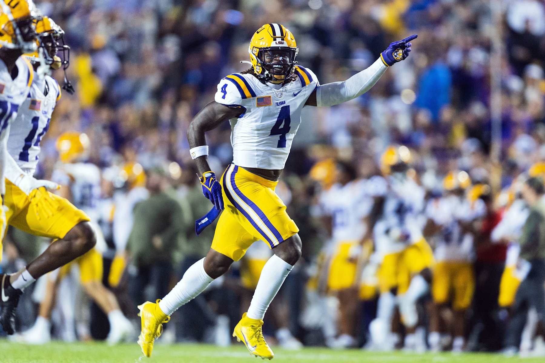 BATON ROUGE, LA - NOVEMBER 11: LSU Tigers linebacker Harold Perkins Jr. (4) celebrates after a turnover during a game between the LSU Tigers and the Florida Gators on November 11, 2023, at Tiger Stadium in Baton Rouge, Louisiana. (Photo by John Korduner/Icon Sportswire via Getty Images)