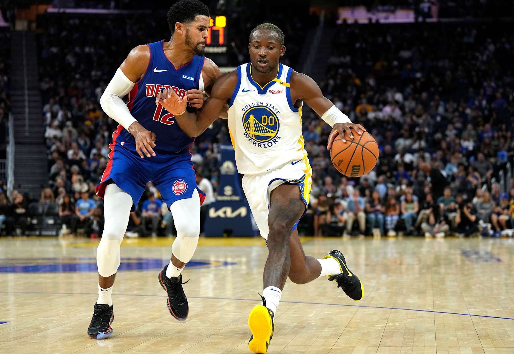 SAN FRANCISCO, CALIFORNIA - OCTOBER 13: Jonathan Kuminga #00 of the Golden State Warriors dribbling the ball is guarded by Tobias Harris #12 of the Detroit Pistons during the second half of an NBA preseason basketball game at Chase Center on October 13, 2024 in San Francisco, California. NOTE TO USER: User expressly acknowledges and agrees that, by downloading and or using this photograph, User is consenting to the terms and conditions of the Getty Images License Agreement. (Photo by Thearon W. Henderson/Getty Images)