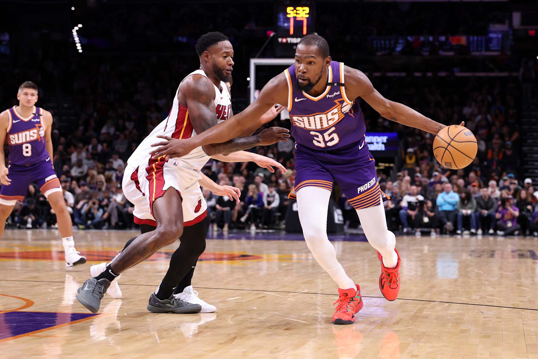 PHOENIX, ARIZONA - NOVEMBER 06: Kevin Durant #35 of the Phoenix Suns dribbles against Haywood Highsmith #24 of the Miami Heat during the game at Footprint Center on November 06, 2024 in Phoenix, Arizona. The Suns defeated the Heat 115-112. NOTE TO USER: User expressly acknowledges and agrees that, by downloading and or using this photograph, User is consenting to the terms and conditions of the Getty Images License Agreement.  (Photo by Chris Coduto/Getty Images)