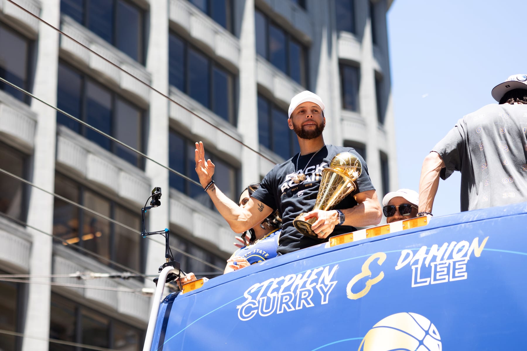 SAN FRANCISCO, CA - JUNE 20: Stephen Curry #30 of the Golden State Warriors holding the Bill Russell NBA Finals MVP Award  and Damion Lee # during their 2022 Victory Parade & Rally on June 20, 2022 at Chase Center in San Francisco, California. NOTE TO USER: User expressly acknowledges and agrees that, by downloading and or using this photograph, user is consenting to the terms and conditions of Getty Images License Agreement. Mandatory Copyright Notice: Copyright 2022 NBAE (Photo by Oscar Urizar/NBAE via Getty Images)