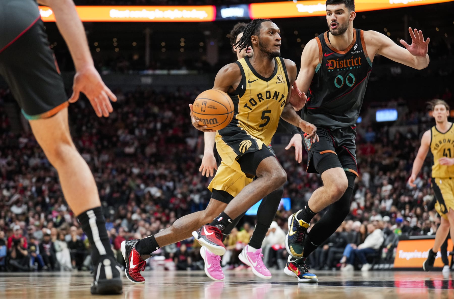 TORONTO, ON - APRIL 7: Immanuel Quickley #5 of the Toronto Raptors dribbles against Tristan Vukcevic #00 of the Washington Wizards during the second half of their basketball game at the Scotiabank Arena on April 7, 2024 in Toronto, Ontario, Canada. NOTE TO USER: User expressly acknowledges and agrees that, by downloading and/or using this Photograph, user is consenting to the terms and conditions of the Getty Images License Agreement. (Photo by Mark Blinch/Getty Images)