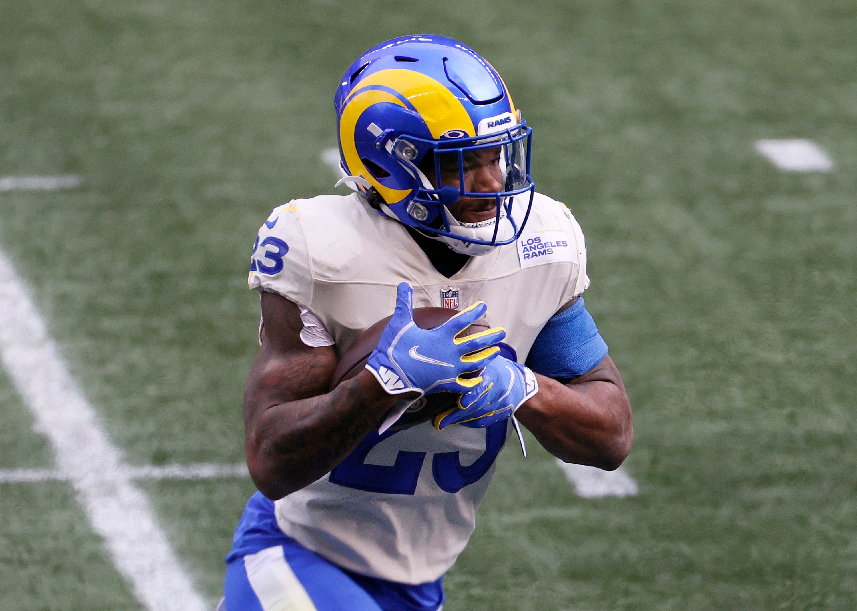 SEATTLE, WASHINGTON - JANUARY 09: Cam Akers #23 of the Los Angeles Rams carries the ball against the Seattle Seahawks during the first quarter in an NFC Wild Card game at Lumen Field on January 09, 2021 in Seattle, Washington. (Photo by Steph Chambers/Getty Images)