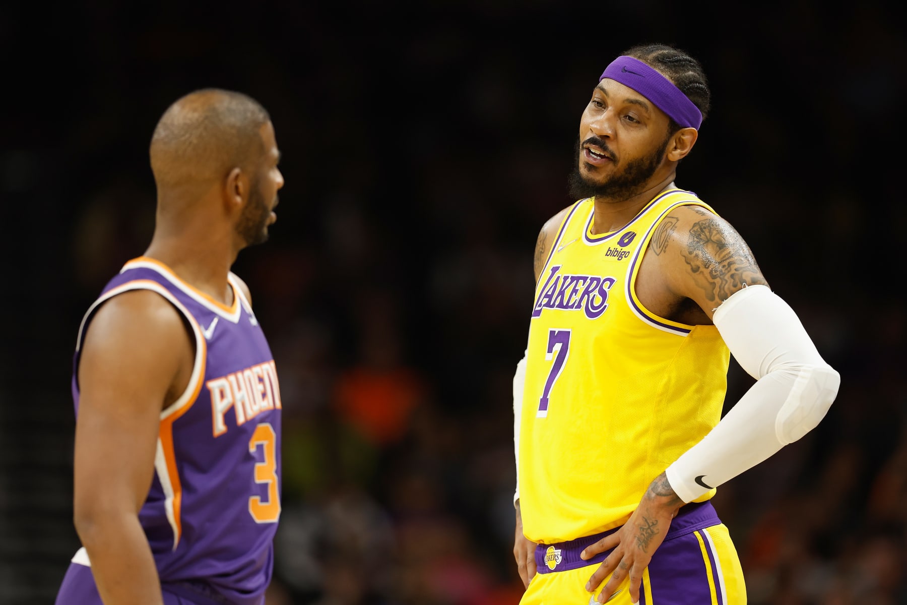 PHOENIX, ARIZONA - APRIL 05: Carmelo Anthony #7 of the Los Angeles Lakers talks with Chris Paul #3 of the Phoenix Suns during the first half of the NBA game at Footprint Center on April 05, 2022 in Phoenix, Arizona.  NOTE TO USER: User expressly acknowledges and agrees that, 
by downloading and or using this photograph, User is consenting to the terms and conditions of the Getty Images License Agreement. (Photo by Christian Petersen/Getty Images)