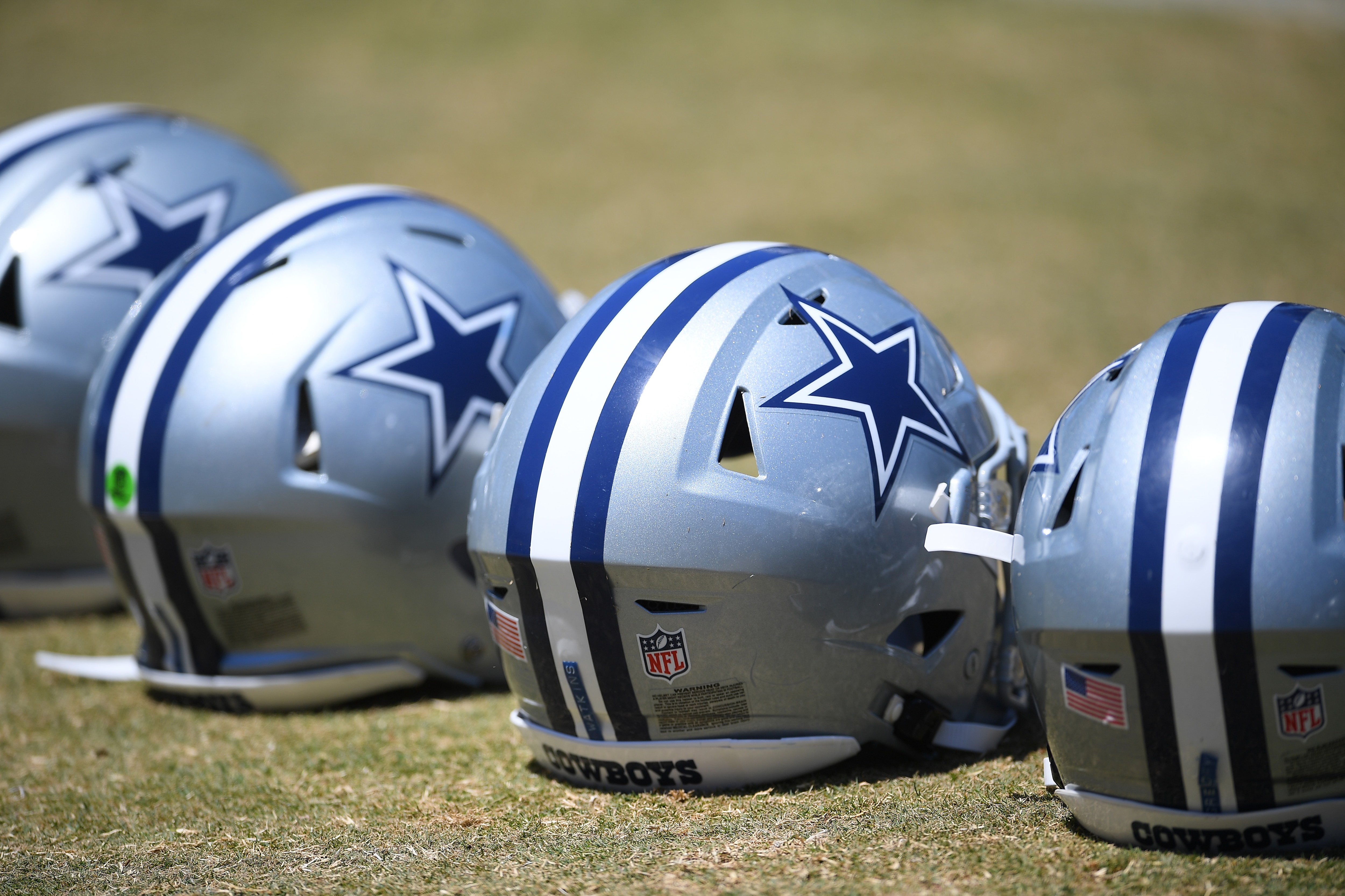 OXNARD, CA - AUGUST 03: A detailed view of helmets of the Dallas Cowboys lined up on the field during training camp at River Ridge Complex on August 3, 2021 in Oxnard, California. (Photo by Jayne Kamin-Oncea/Getty Images)