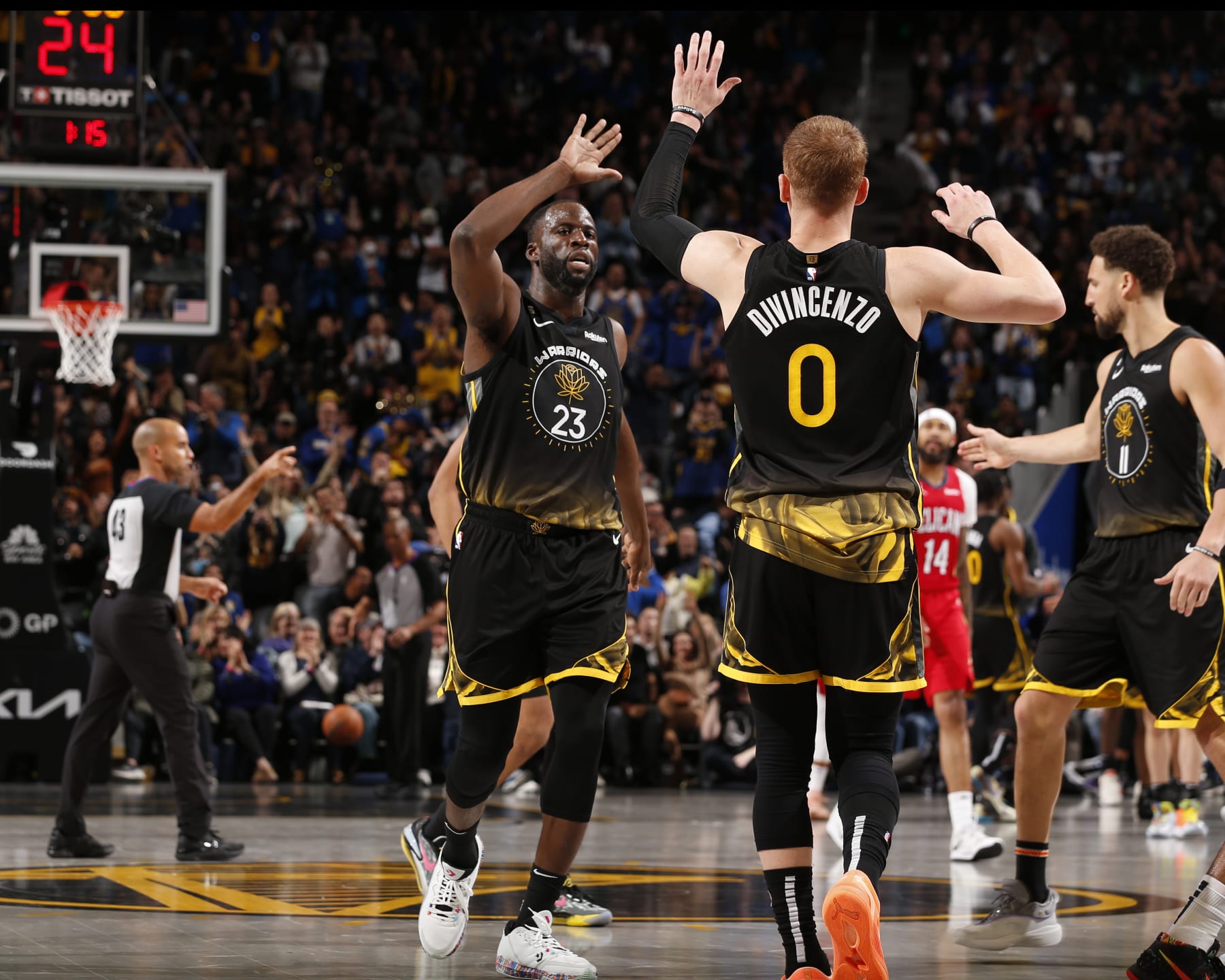 SAN FRANCISCO, CA - MARCH 3:  Donte DiVincenzo #0 and Draymond Green #23 of the Golden State Warriors high five during the game on March 3, 2023 at Chase Center in San Francisco, California. NOTE TO USER: User expressly acknowledges and agrees that, by downloading and or using this photograph, user is consenting to the terms and conditions of Getty Images License Agreement. Mandatory Copyright Notice: Copyright 2023 NBAE (Photo by Jed Jacobsohn/NBAE via Getty Images)