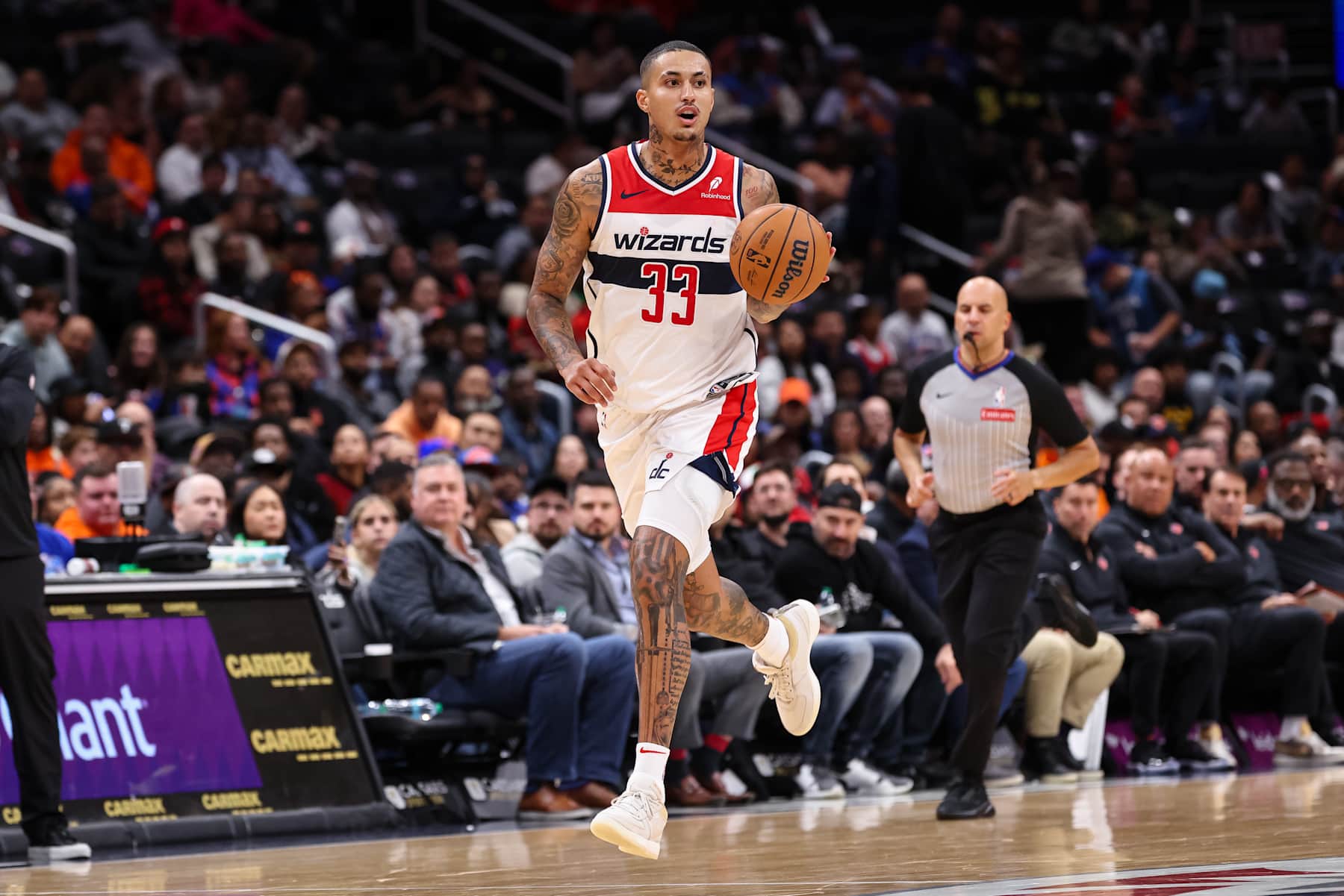 WASHINGTON, DC - OCTOBER 18: Kyle Kuzma #33 of the Washington Wizards brings the ball up court against the New York Knicks during the first half of the preseason game at Capital One Arena on October 18, 2024 in Washington, DC. NOTE TO USER: User expressly acknowledges and agrees that, by downloading and or using this photograph, User is consenting to the terms and conditions of the Getty Images License Agreement. (Photo by Scott Taetsch/Getty Images)