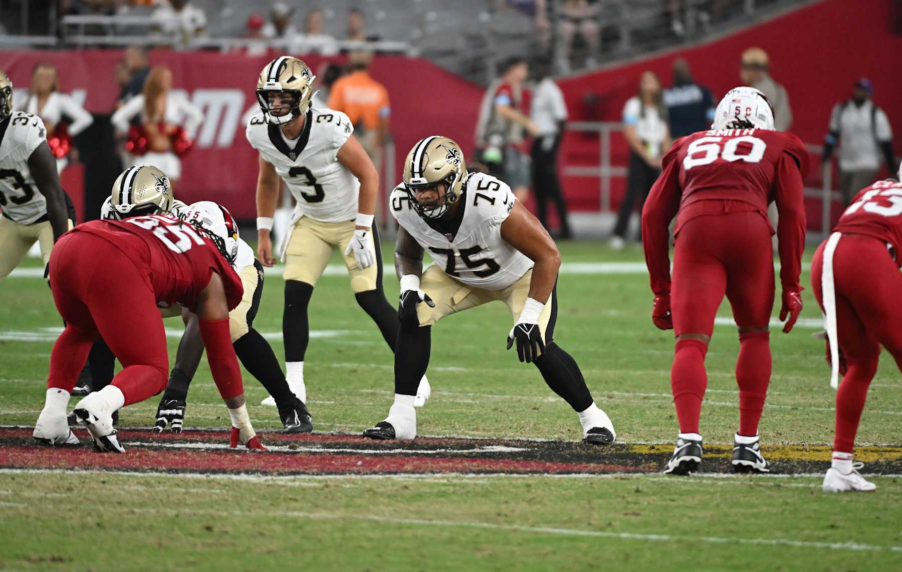 GLENDALE, ARIZONA - AUGUST 10: Taliese Fuaga #75 of the New Orleans Saints gets ready to pass block against the Arizona Cardinals at State Farm Stadium on August 10, 2024 in Glendale, Arizona.  (Photo by Norm Hall/Getty Images)