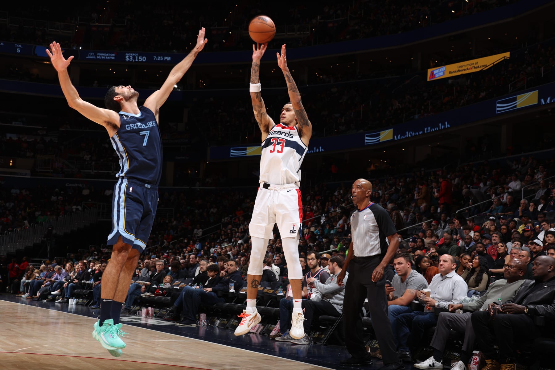 WASHINGTON, DC -  NOVEMBER 13: Kyle Kuzma #33 of the Washington Wizards shoots a three point basket during the game against the Memphis Grizzlies on November 13, 2022 at Capital One Arena in Washington, DC. NOTE TO USER: User expressly acknowledges and agrees that, by downloading and or using this Photograph, user is consenting to the terms and conditions of the Getty Images License Agreement. Mandatory Copyright Notice: Copyright 2022 NBAE (Photo by Stephen Gosling/NBAE via Getty Images)