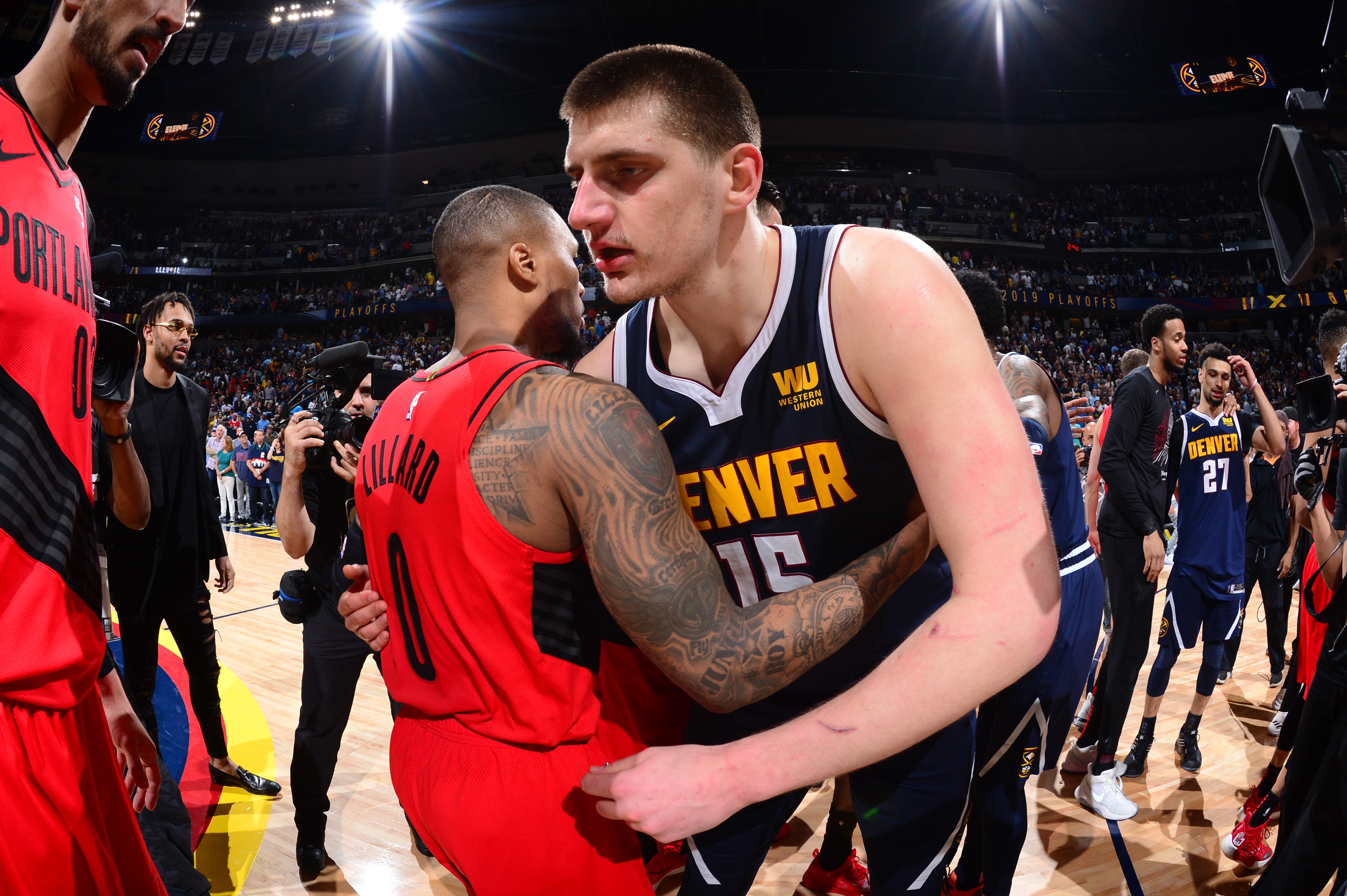 DENVER, CO - MAY 12: Damian Lillard #0 of the Portland Trail Blazers congratulates Nikola Jokic #15 of the Denver Nuggets after the game during Game Seven of the Western Conference Semifinals of the 2019 NBA Playoffs on May 12, 2019 at the Pepsi Center in Denver, Colorado. NOTE TO USER: User expressly acknowledges and agrees that, by downloading and/or using this Photograph, user is consenting to the terms and conditions of the Getty Images License Agreement. Mandatory Copyright Notice: Copyright 2019 NBAE (Photo by Bart Young/NBAE via Getty Images)