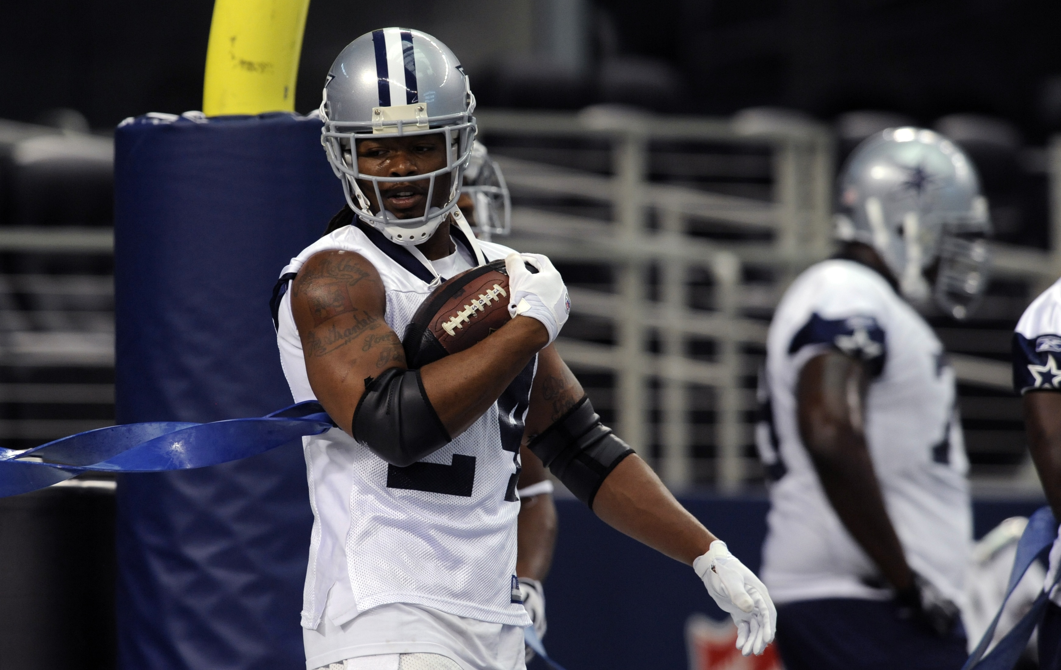 Dallas Cowboys running back Marion Barber (24) holds onto the ball during at football practice at Cowboys Stadium in Arlington, Texas, Wednesday, June 2, 2010. (AP Photo/Cody Duty)
