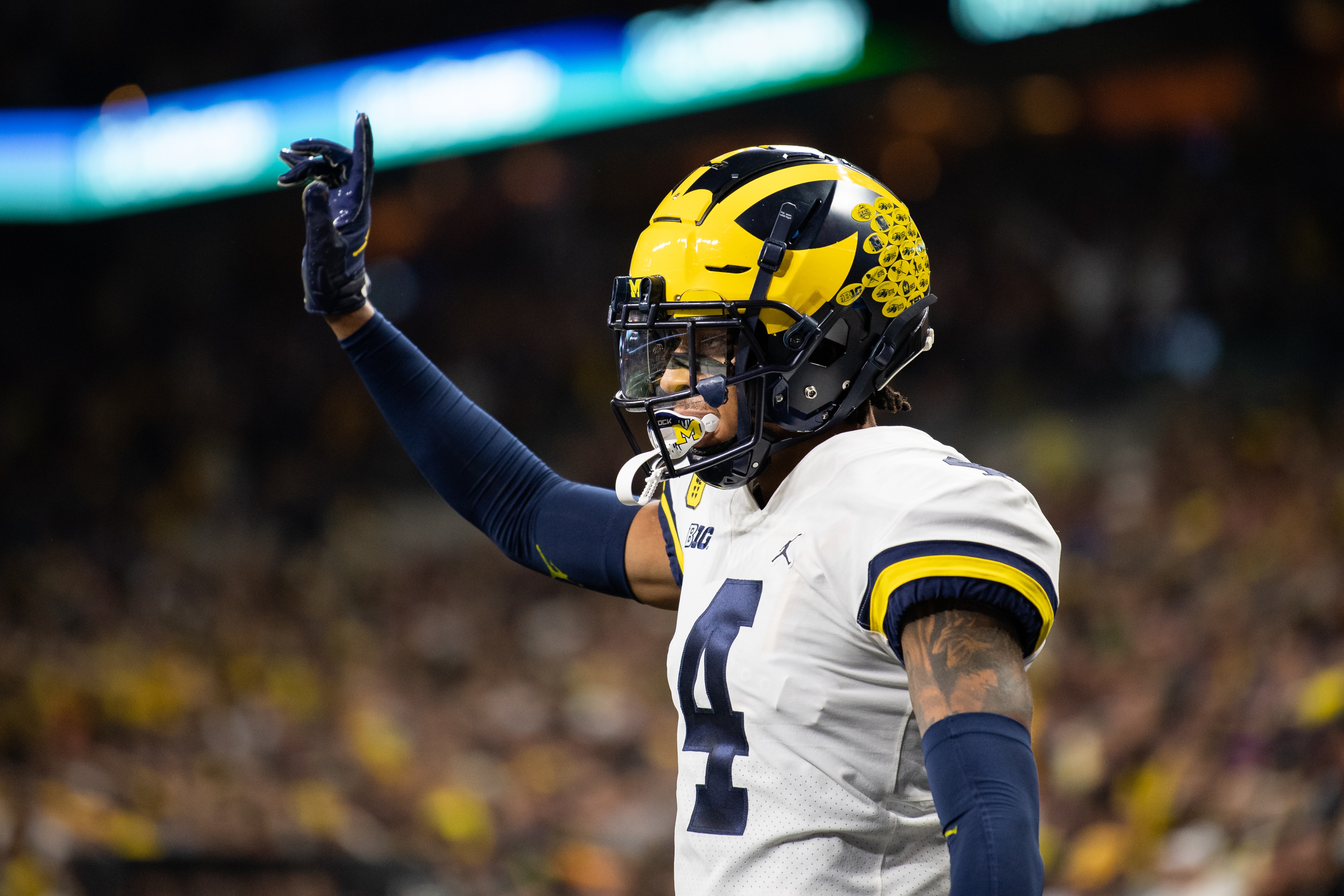 INDIANAPOLIS, IN - DECEMBER 04: Michigan Wolverines defensive back Vincent Gray (4) celebrates a defensive stop during the Big 10 Championship game between the Michigan Wolverines and Iowa Hawkeyes on December 4, 2021, at Lucas Oil Stadium in Indianapolis, IN. (Photo by Zach Bolinger/Icon Sportswire via Getty Images)