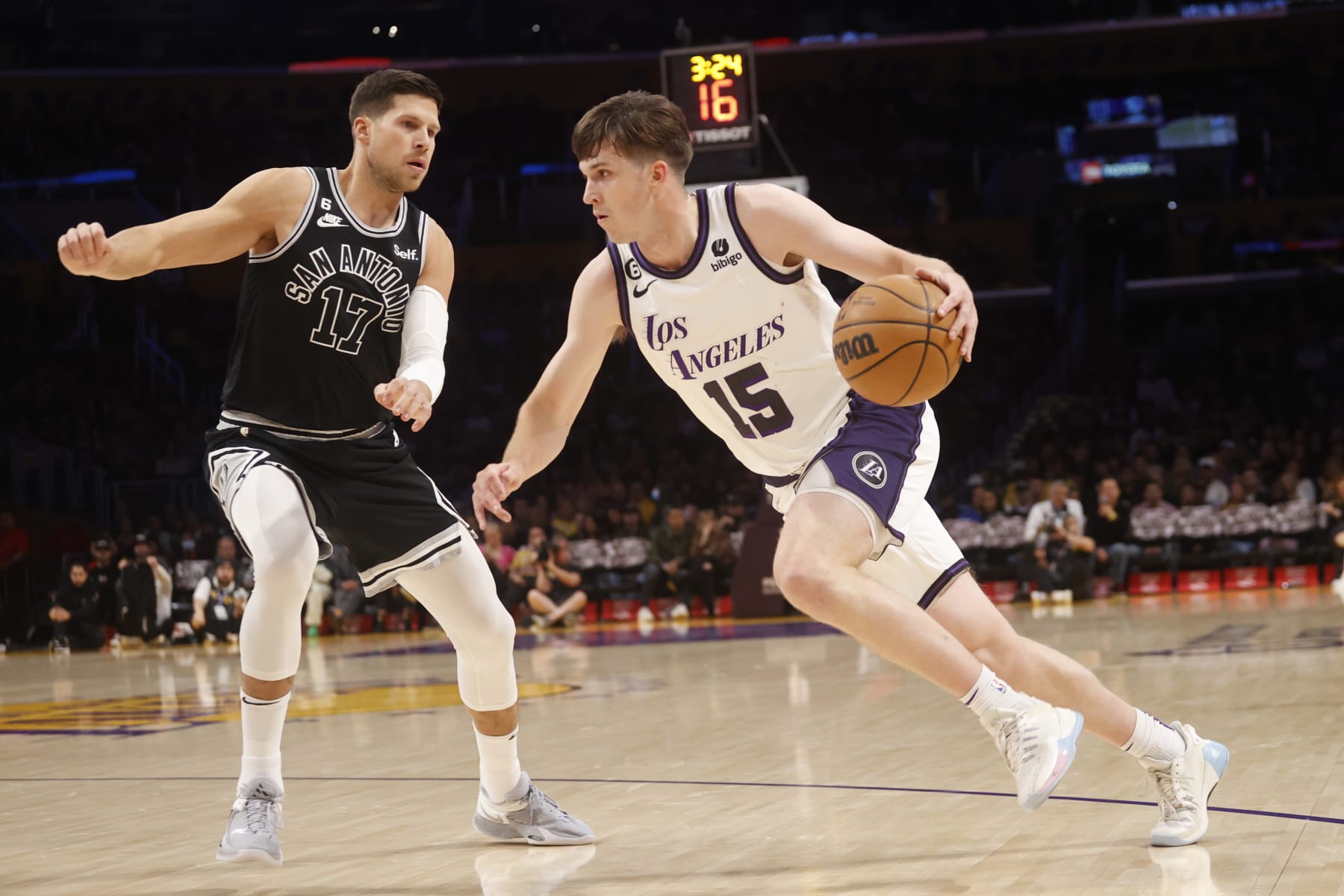 Los Angeles Lakers guard Austin Reaves (15) drives against San Antonio Spurs forward Doug McDermott (17) during the first half of an NBA basketball game Sunday, Nov. 20, 2022 in Los Angeles. (AP Photo/Ringo H.W. Chiu)