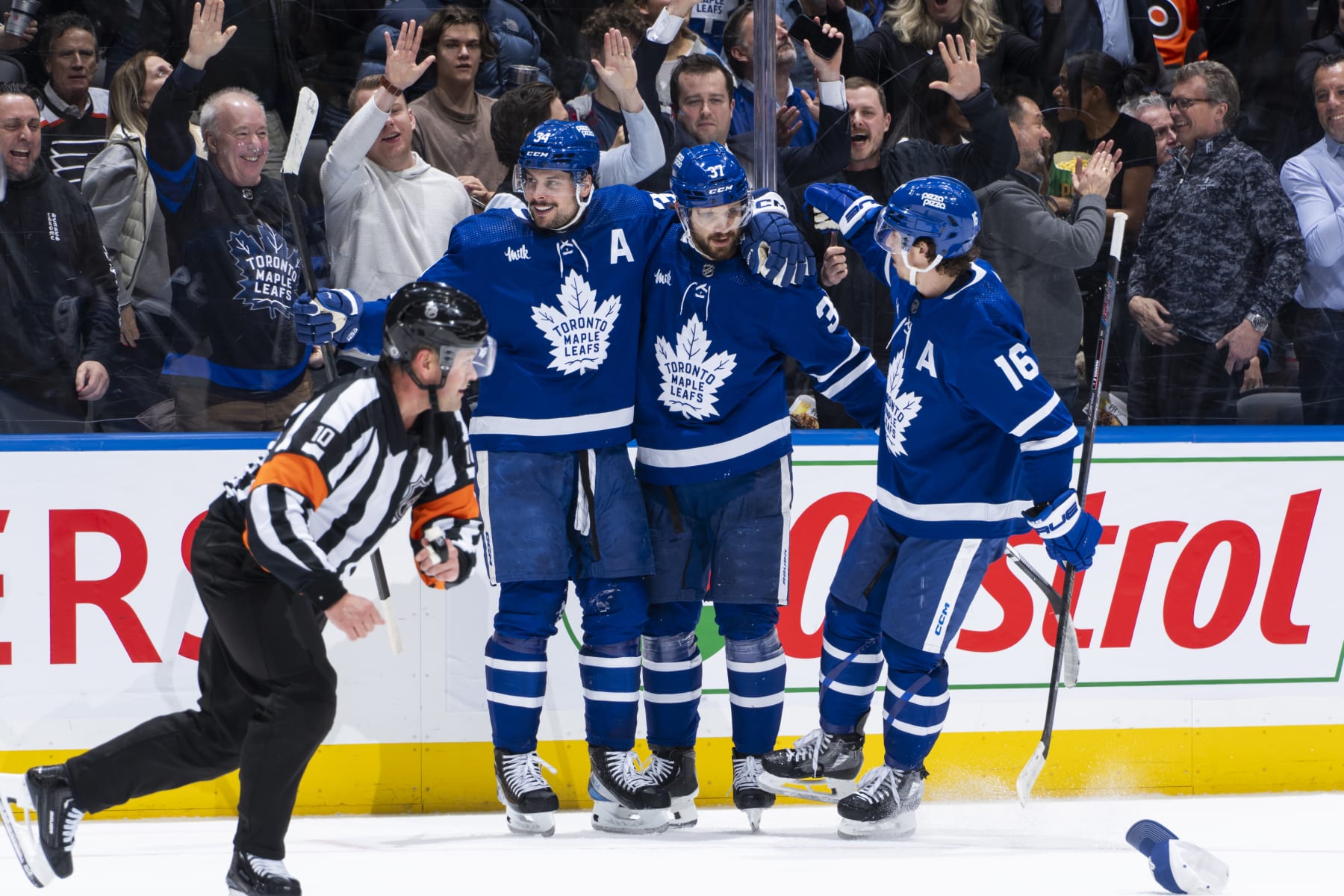 TORONTO, ON - FEBRUARY 15: Auston Matthews #34 of the Toronto Maple Leafs celebrates his third goal of the game against the Philadelphia Flyers with teammates Timothy Liljegren #37 and Mitchell Marner #16 during the second period at Scotiabank Arena on February 15, 2024 in Toronto, Ontario, Canada. (Photo by Kevin Sousa/NHLI via Getty Images)
