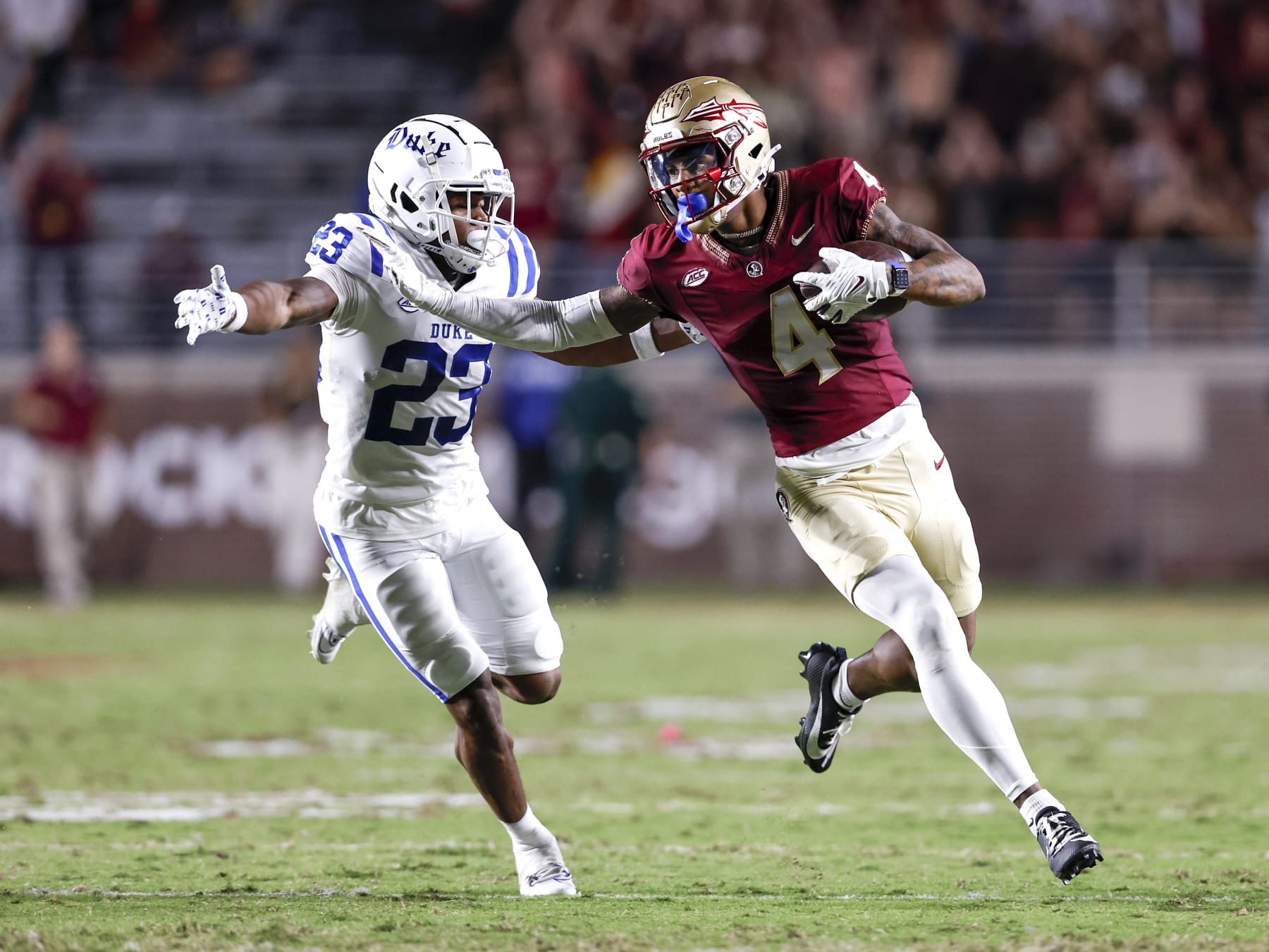 TALLAHASSEE, FL - OCTOBER 21: Wide Receiver Keon Coleman #4 of the Florida State Seminoles runs with the ball against Terry Moore #23 of the Duke Blue Devils after a catch and run at Doak Campbell Stadium on Bobby Bowden Field on October 21, 2023 in Tallahassee, Florida. (Photo by Don Juan Moore/Getty Images)