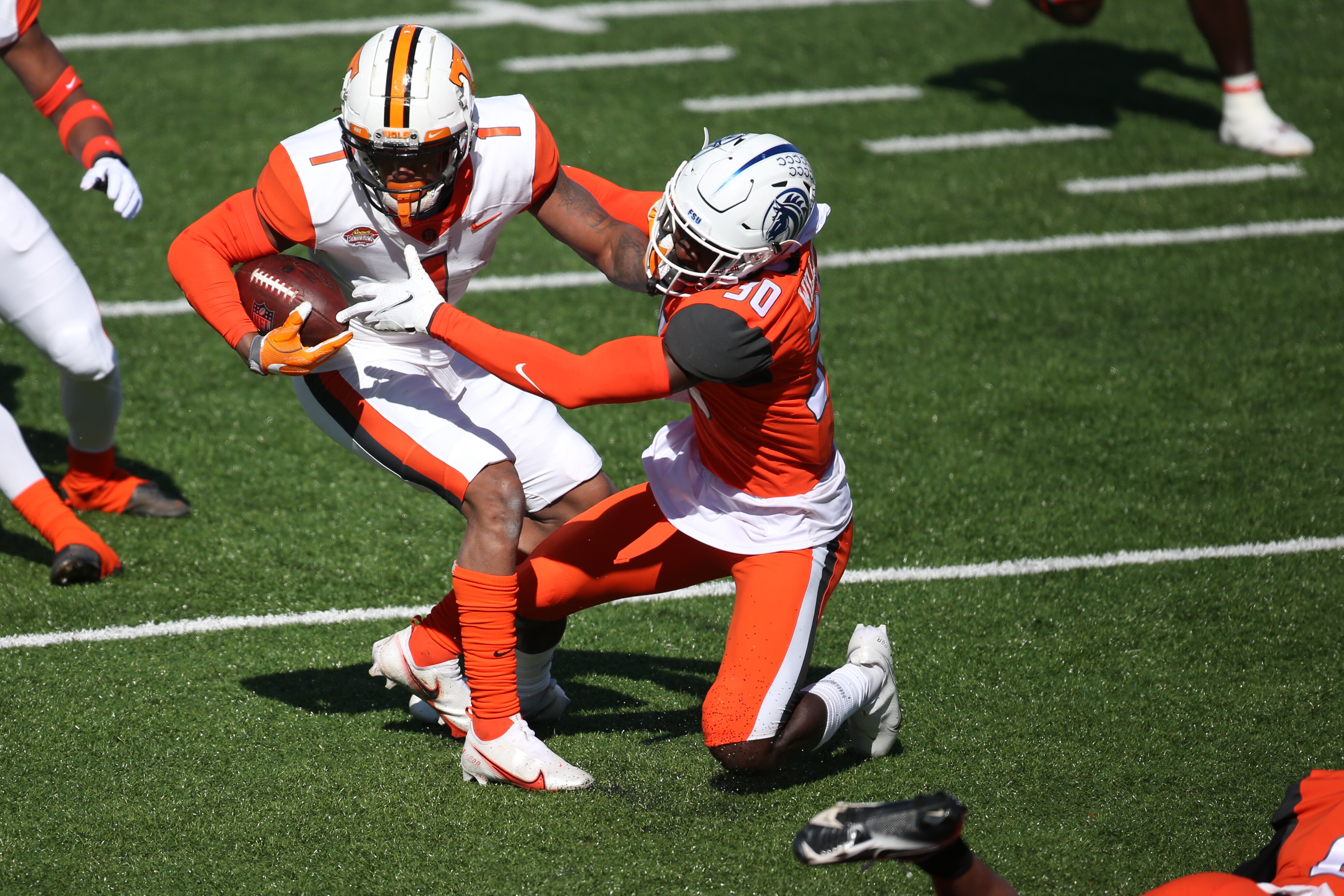 MOBILE, AL - FEBRUARY 05: National defensive back Joshua Williams of Fayetteville State (30) attempts a tackle during the Reese's Senior Bowl on February 5, 2022 at Hancock Whitney Stadium in Mobile, Alabama.  (Photo by Michael Wade/Icon Sportswire via Getty Images)