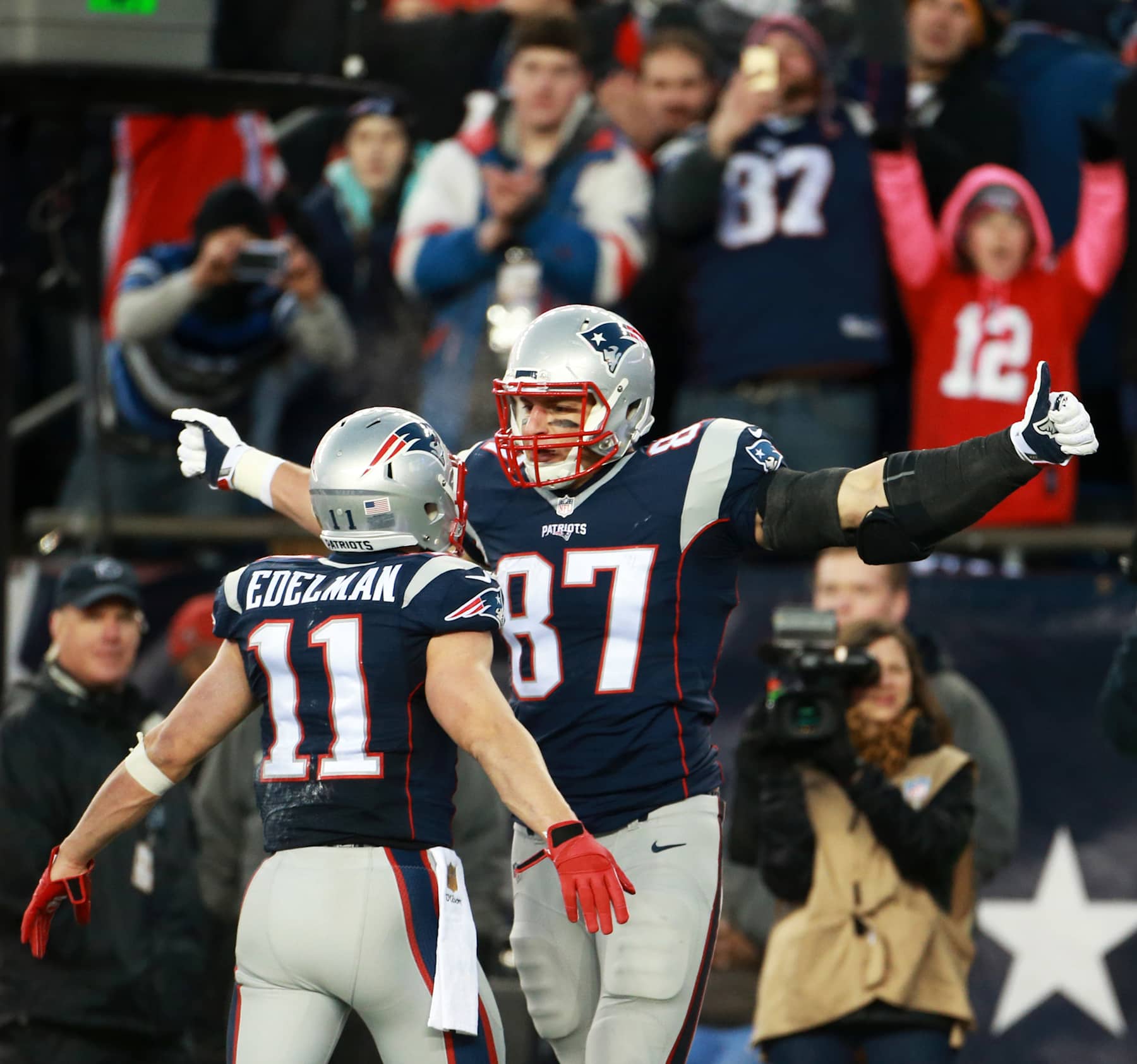 FOXBOROUGH, MA - JANUARY 16: Fans cheer as Patriots tight end Rob Gronkowski (right, 87) and wide receiver Julian Edelman (left, 11) celebrate after Gronkowski's first quarter 8-yard touchdown pass. The New England Patriots hosted the Kansas City Chiefs in an AFC divisional playoff game at Gillette Stadium in Foxborough, Mass., Saturday, Jan. 16, 2016. (Photo by Jim Davis/The Boston Globe via Getty Images)