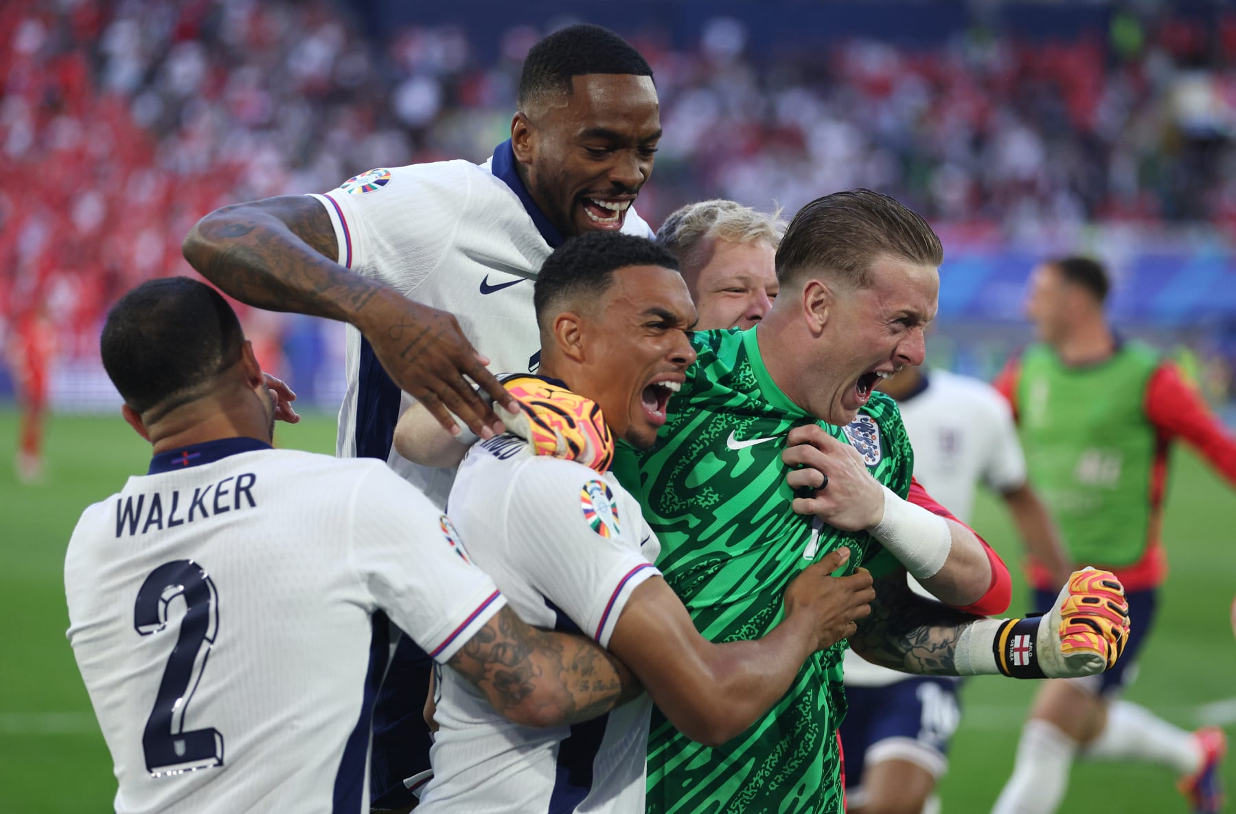 DUSSELDORF, GERMANY - JULY 06: Trent Alexander-Arnold of England celebrates scoring the team's fifth and winning penalty in the penalty shoot out with teammates Kyle Walker, Ivan Toney and Jordan Pickford  during the UEFA EURO 2024 quarter-final match between England and Switzerland at Düsseldorf Arena on July 06, 2024 in Dusseldorf, Germany. (Photo by Dean Mouhtaropoulos/Getty Images)