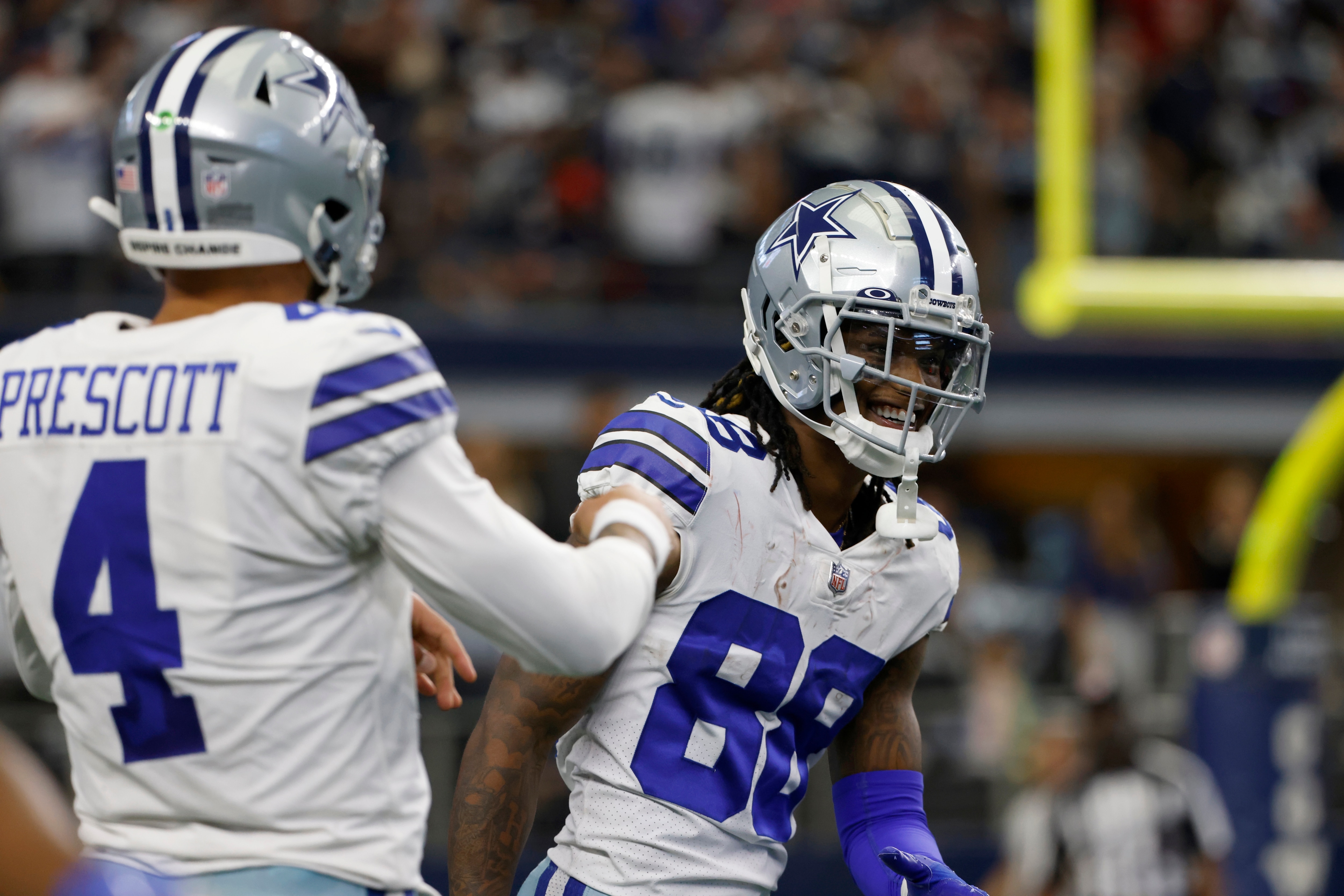 Dallas Cowboys' Dak Prescott (4) and CeeDee Lamb (88) celebrate after Lamb's touchdown catch in the first half of an NFL football game against the Atlanta Falcons in Arlington, Texas, Sunday, Nov. 14, 2021. (AP Photo/Ron Jenkins)