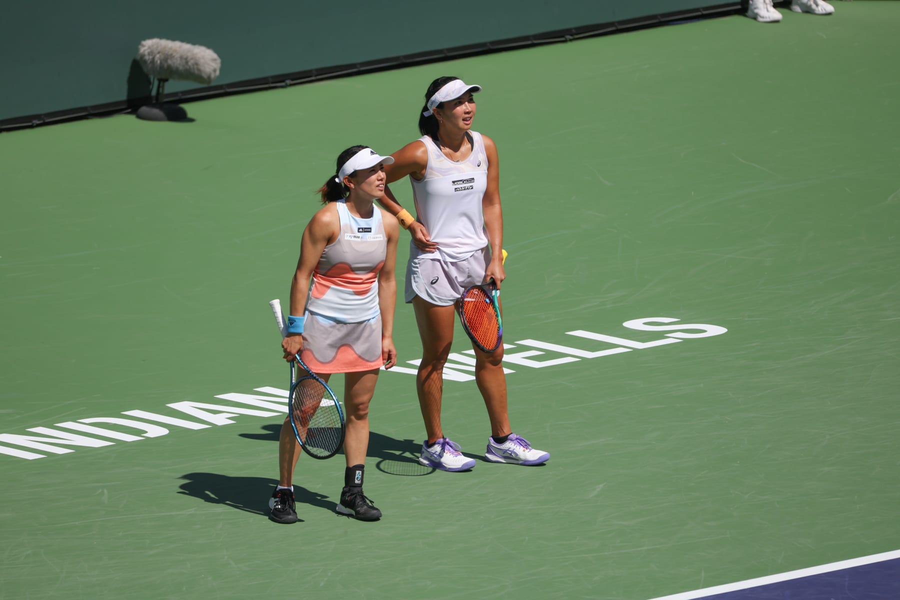 INDIAN WELLS, CA - MARCH 17: Miyu Kato (JPN) and Aldila Sutjiadi (INA) look across the court to their doubles opponents during the BNP Paribas Open on March 17, 2023 at the Indian Wells Tennis Garden in Indian Wells, CA. (Photo by George Walker/Icon Sportswire via Getty Images)