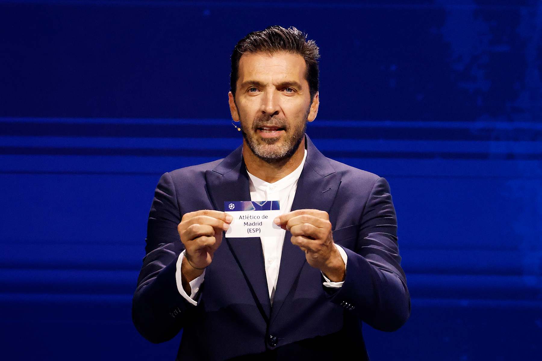 MONACO, MONACO - AUGUST 29: Gianluigi Buffon, Winner of UEFA President's Award 2024 draws out the name of Atletico de Madrid during the UEFA Champions League 2024/25 Group Stage Draw at Grimaldi Forum on August 29, 2024 in Monaco, Monaco.  (Photo by Claudio Lavenia - UEFA/UEFA via Getty Images)
