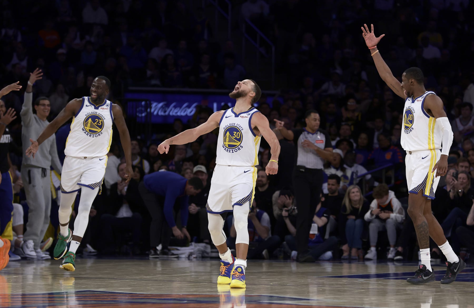 NEW YORK, NEW YORK - FEBRUARY 29: (NEW YORK DAILIES OUT)  Stephen Curry #30, Draymond Green #23 and Jonathan Kuminga #00 of the Golden State Warriors react against the New York Knicks at Madison Square Garden on February 29, 2024 in New York City. The Warriors defeated the Knicks 110-99. NOTE TO USER: User expressly acknowledges and agrees that, by downloading and or using this photograph, User is consenting to the terms and conditions of the Getty Images License Agreement. (Photo by Jim McIsaac/Getty Images)