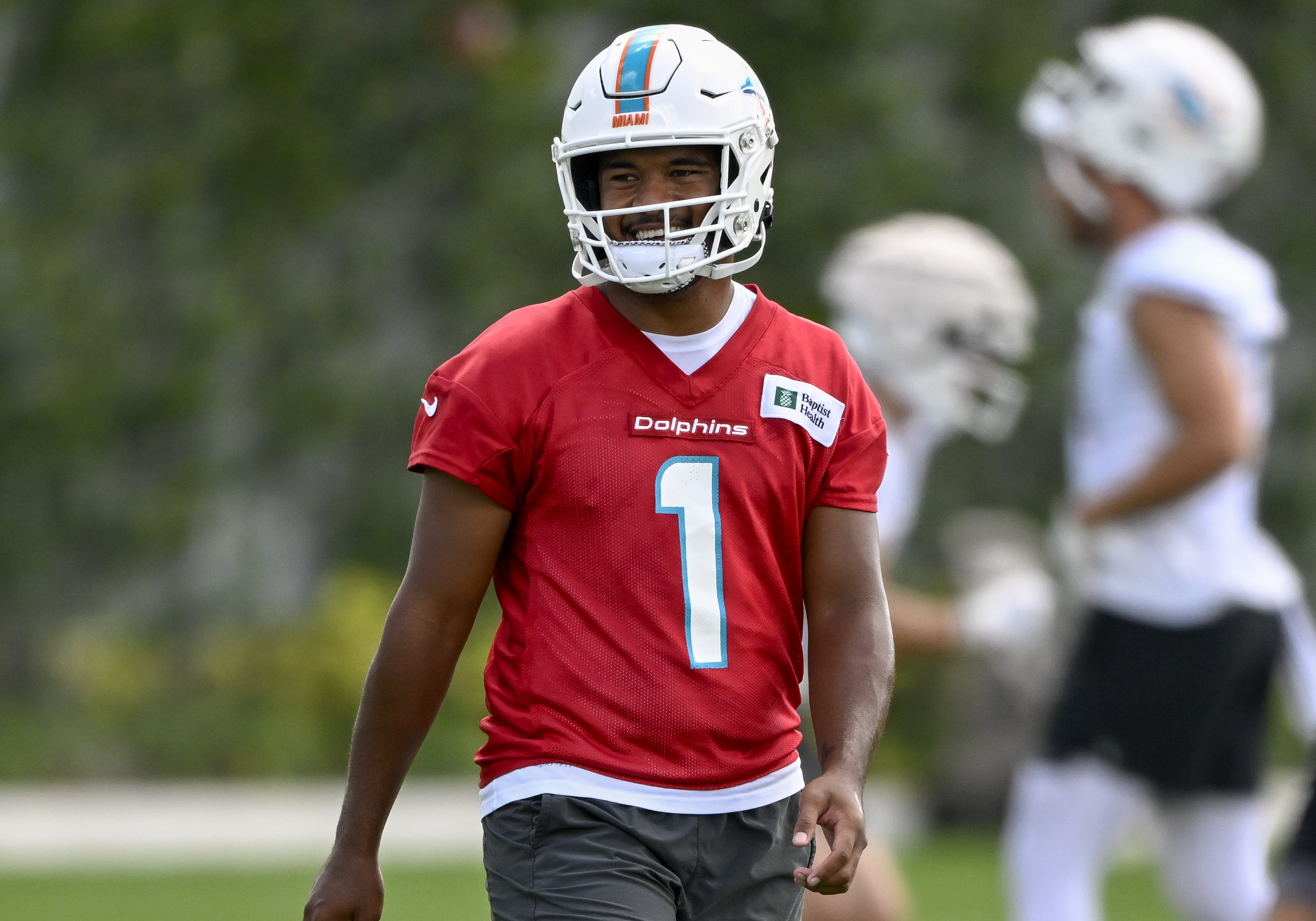 DAVIE, FL - JUNE 01: Miami Dolphins quarterback Tua Tagovailoa (1) laughs during the first mandatory  minicamp at the Baptist Health Training Complex on June 1, 2022, in Miami Gardens, Florida. (Photo by Doug Murray/Icon Sportswire via Getty Images)