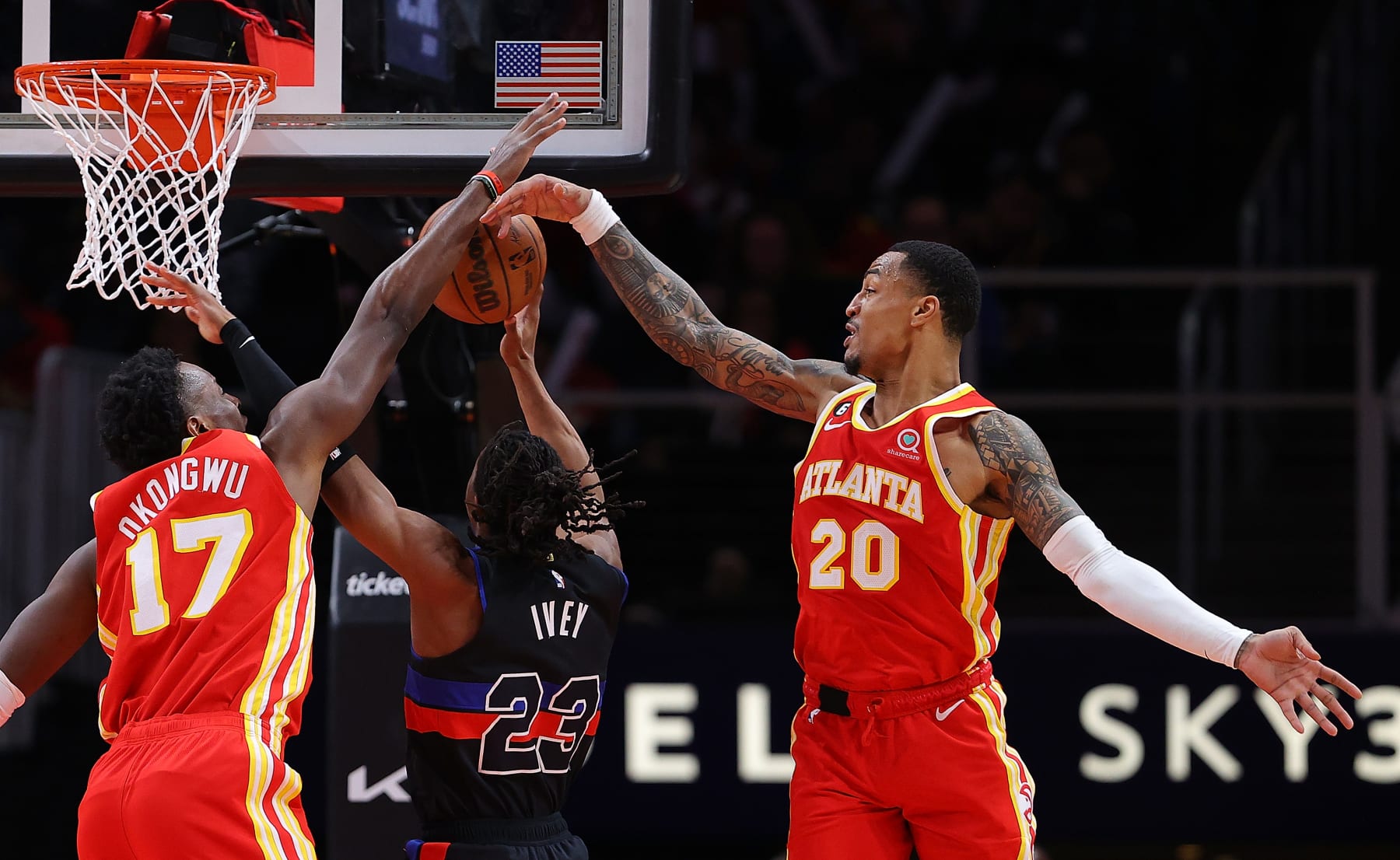 ATLANTA, GEORGIA - DECEMBER 23:  Onyeka Okongwu #17 and John Collins #20 of the Atlanta Hawks block a shot by Jaden Ivey #23 of the Detroit Pistons during the fourth quarter at State Farm Arena on December 23, 2022 in Atlanta, Georgia.  NOTE TO USER: User expressly acknowledges and agrees that, by downloading and or using this photograph, User is consenting to the terms and conditions of the Getty Images License Agreement.  (Photo by Kevin C. Cox/Getty Images)