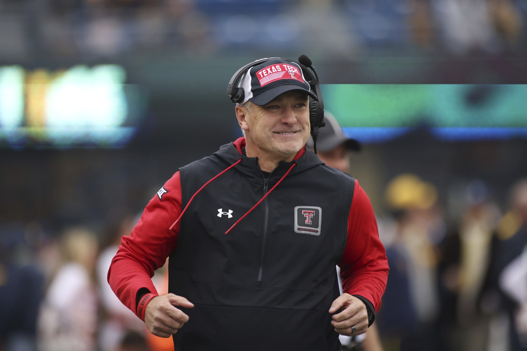 Texas Tech head coach Joey McGuire runs on to the field during the first half of an NCAA college football game, Saturday, Sept. 23, 2023, in Morgantown, W.Va. (AP Photo/Chris Jackson)
