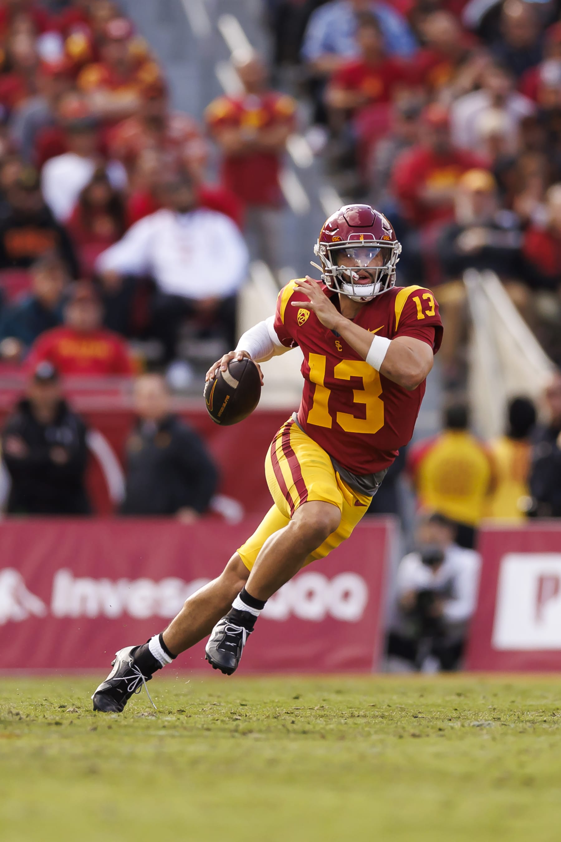 LOS ANGELES, CALIFORNIA - NOVEMBER 18: Caleb Williams #13 of the USC Trojans looks to throw a pass as he scrambles during the first half of a game against the UCLA Bruins at United Airlines Field at the Los Angeles Memorial Coliseum on November 18, 2023 in Los Angeles, California. (Photo by Ryan Kang/Getty Images)
