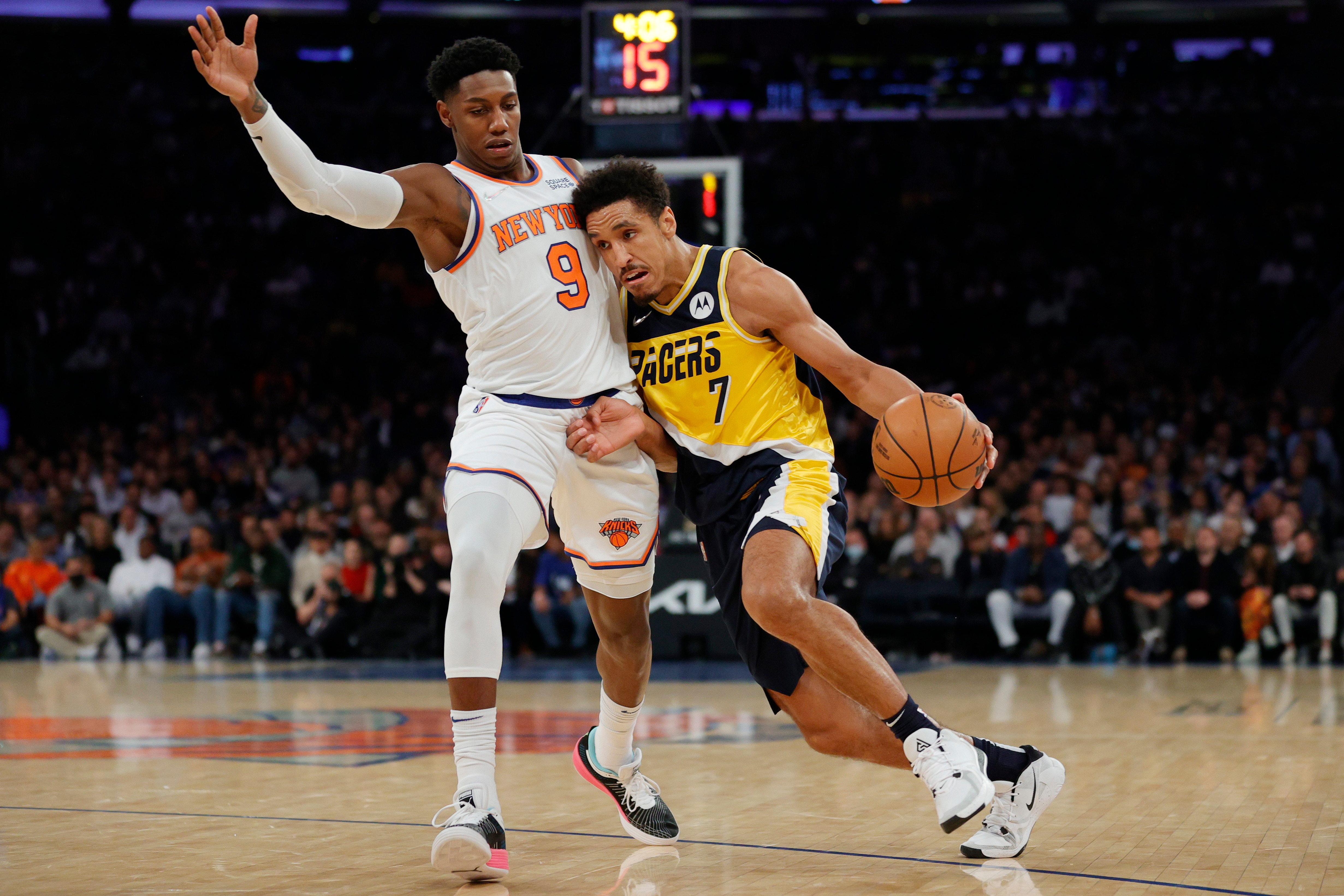 NEW YORK, NEW YORK - NOVEMBER 15: Malcolm Brogdon #7 of the Indiana Pacers dribbles against RJ Barrett #9 of the New York Knicks during the first half at Madison Square Garden on November 15, 2021 in New York City. NOTE TO USER: User expressly acknowledges and agrees that, by downloading and or using this photograph, user is consenting to the terms and conditions of the Getty Images License Agreement. (Photo by Sarah Stier/Getty Images)